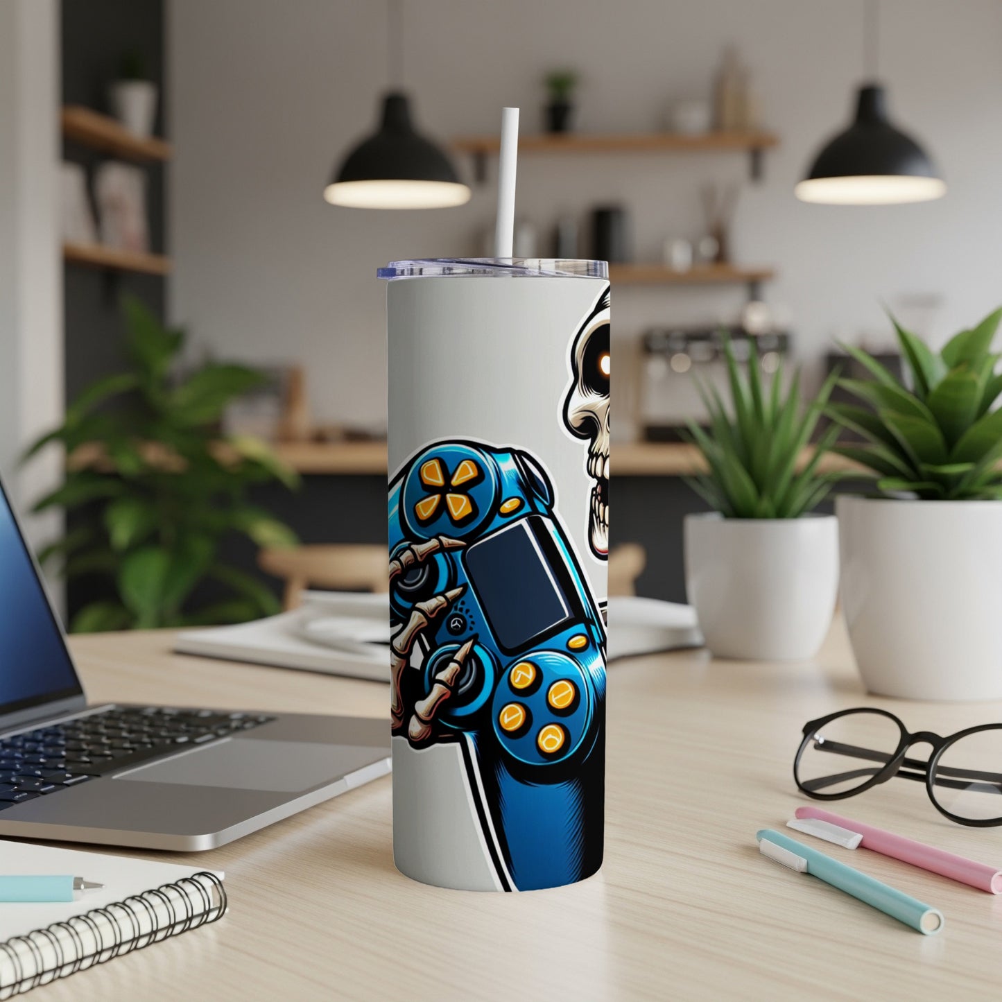 Skeleton holding a blue and yellow video game controller on a tumbler.
