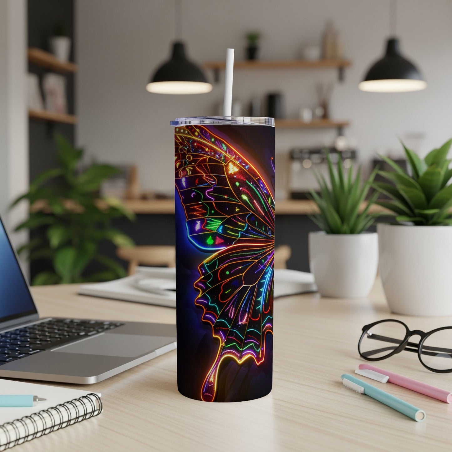 Neon butterfly design on a tall, skinny tumbler with a straw.