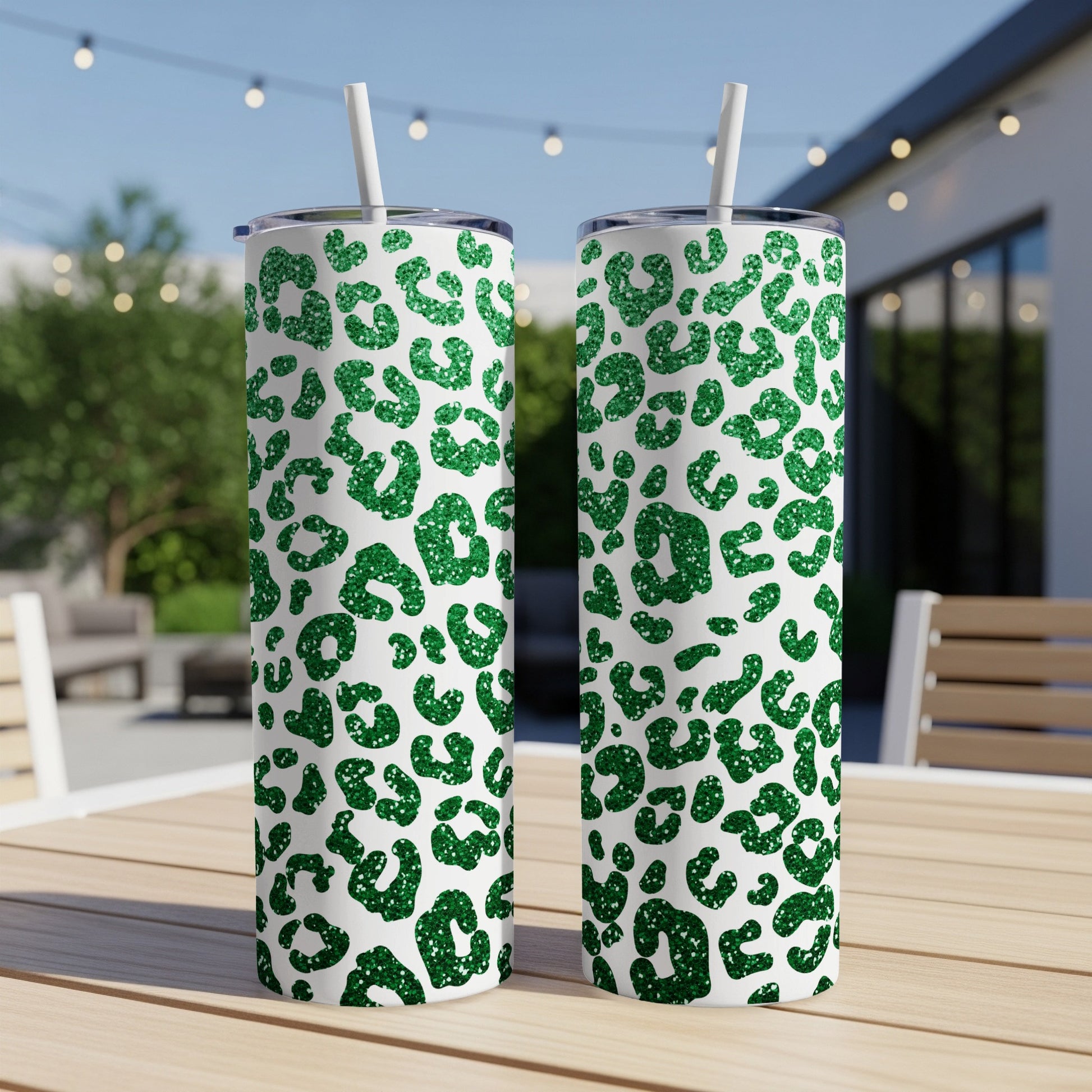Two tall tumblers with a green glitter leopard print pattern.