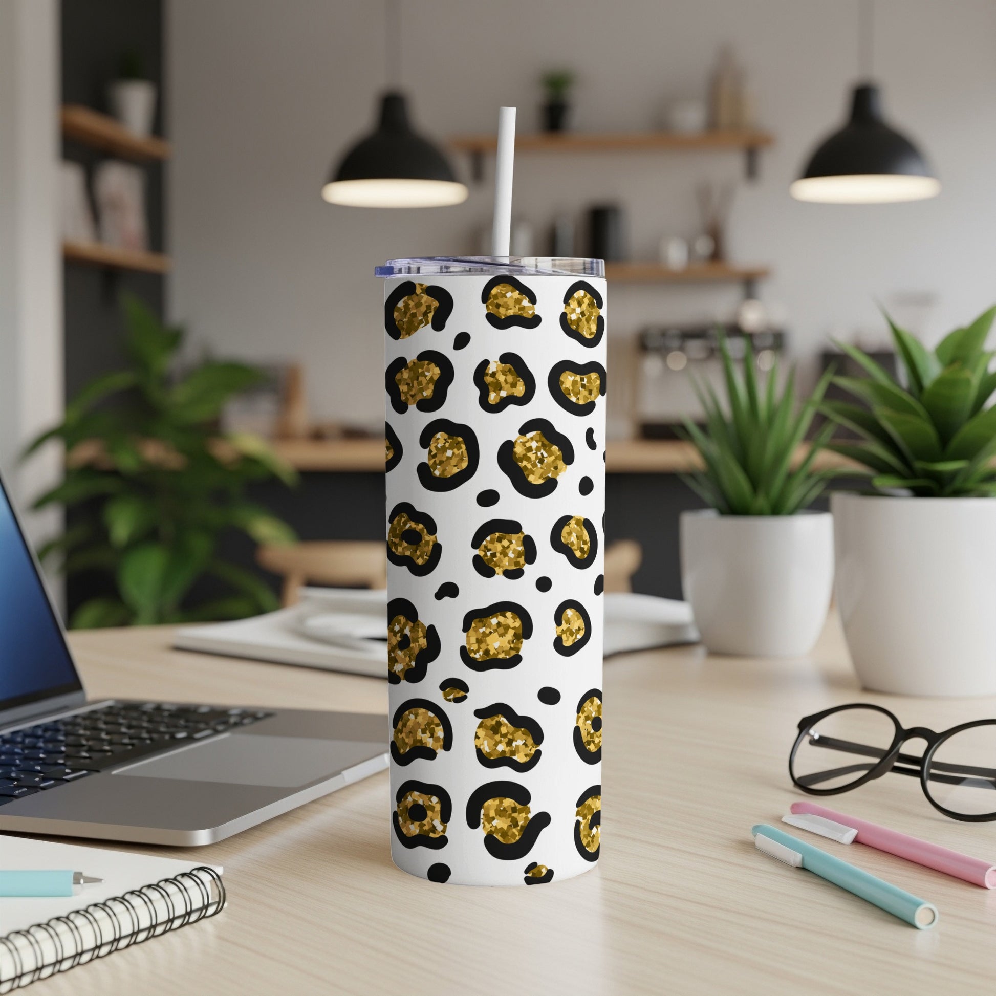 White tumbler with black and gold leopard print and straw.