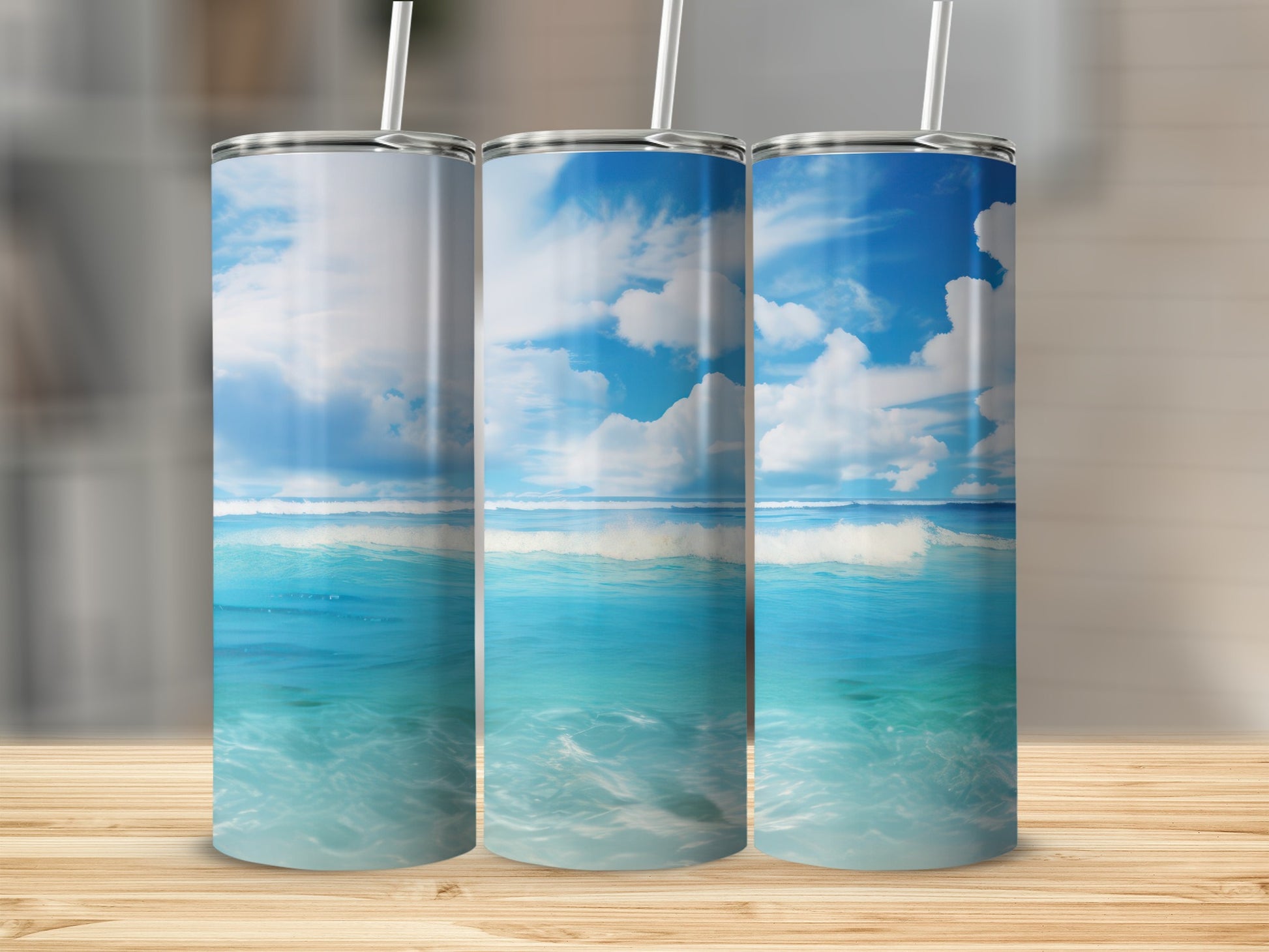 Three tumblers with a tropical beach and ocean wave design.