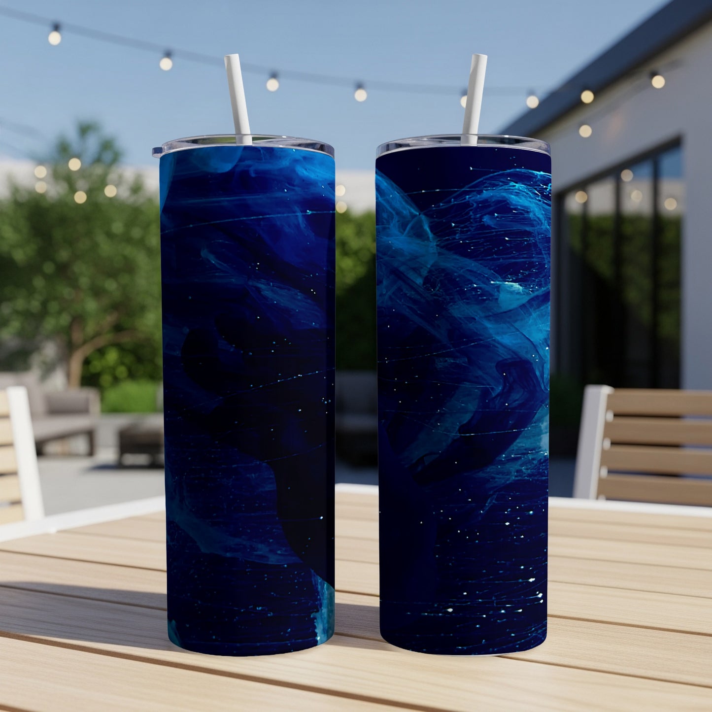 Two dark blue tumblers with abstract swirling blue and white cosmic patterns.