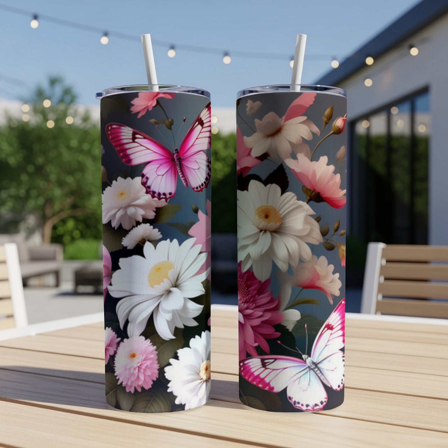 Two tumblers with pink butterflies and white and pink flowers on a dark background.