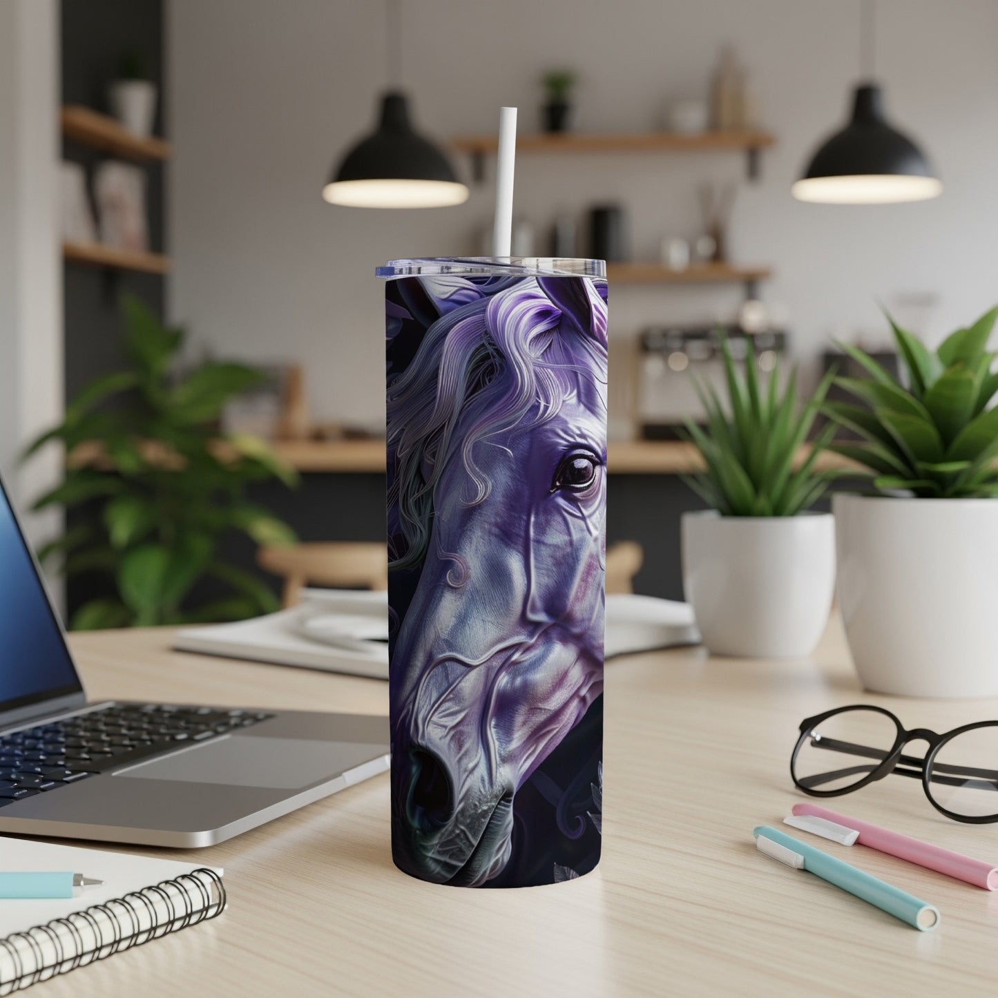 Purple horse design on a white tumbler with a straw on a desk.