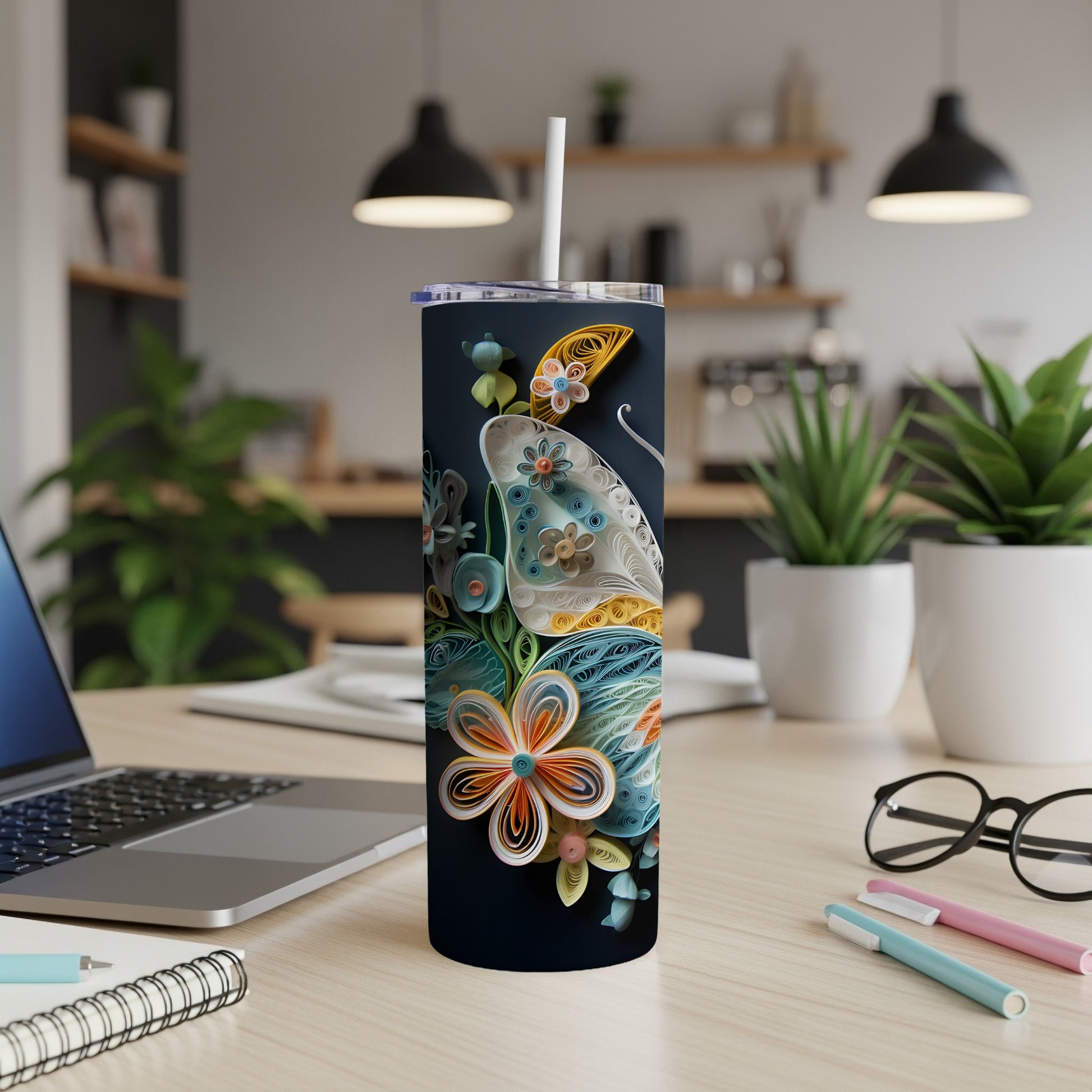 Dark tumbler with intricate floral and butterfly quilling art, including a straw.