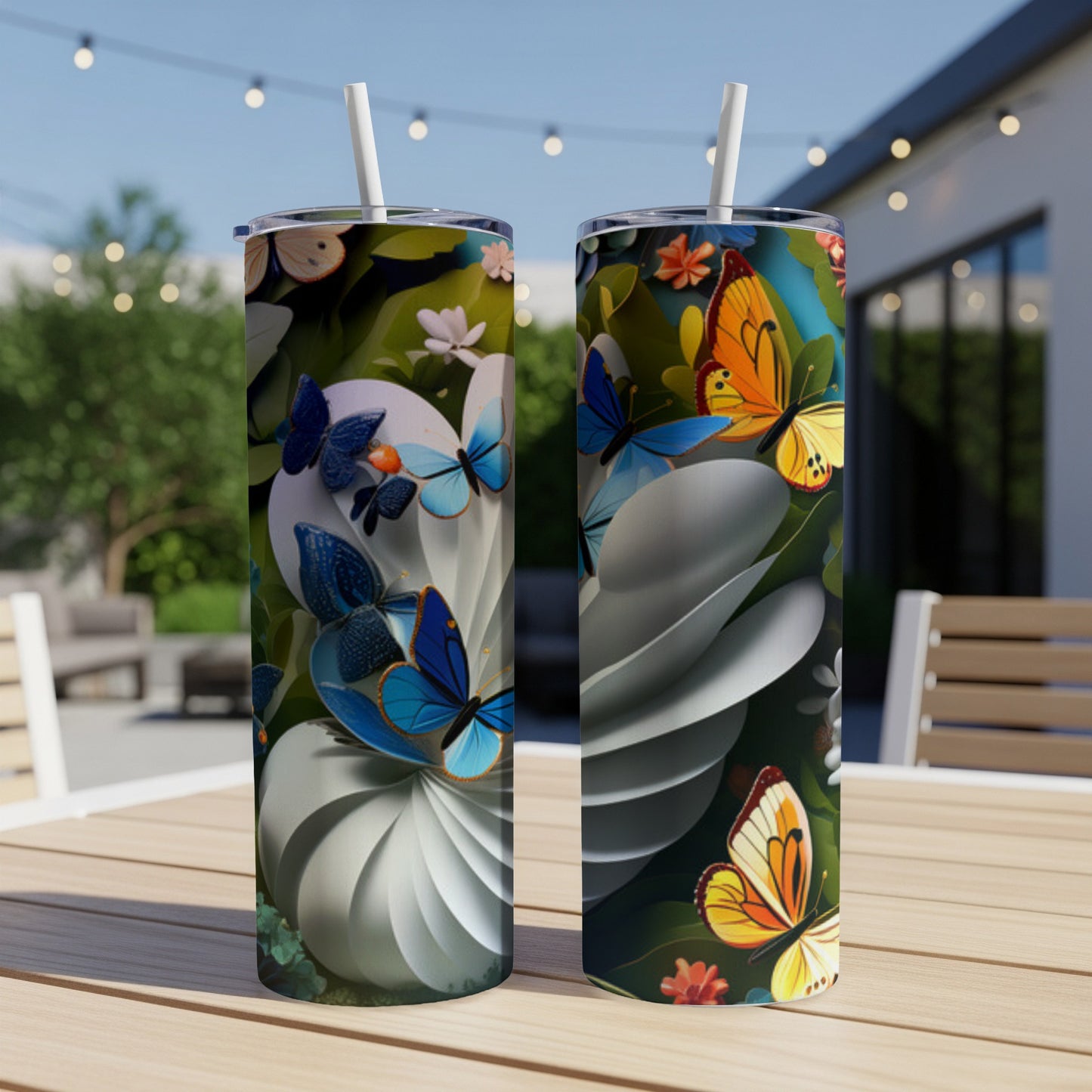 Two tumblers with colorful butterflies and floral designs sit on a table.