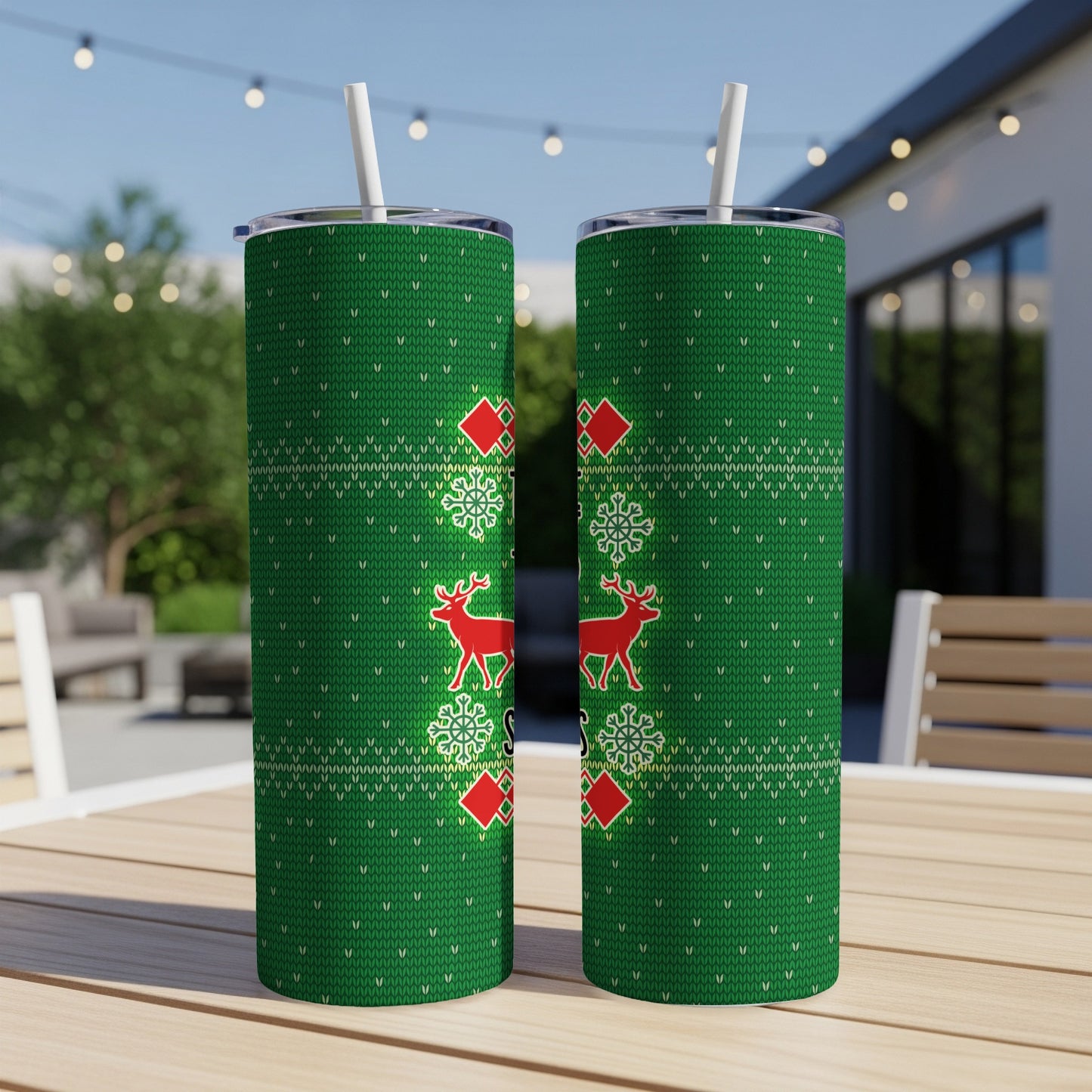 Two green tumblers with a red and white snowflake and reindeer holiday sweater pattern.
