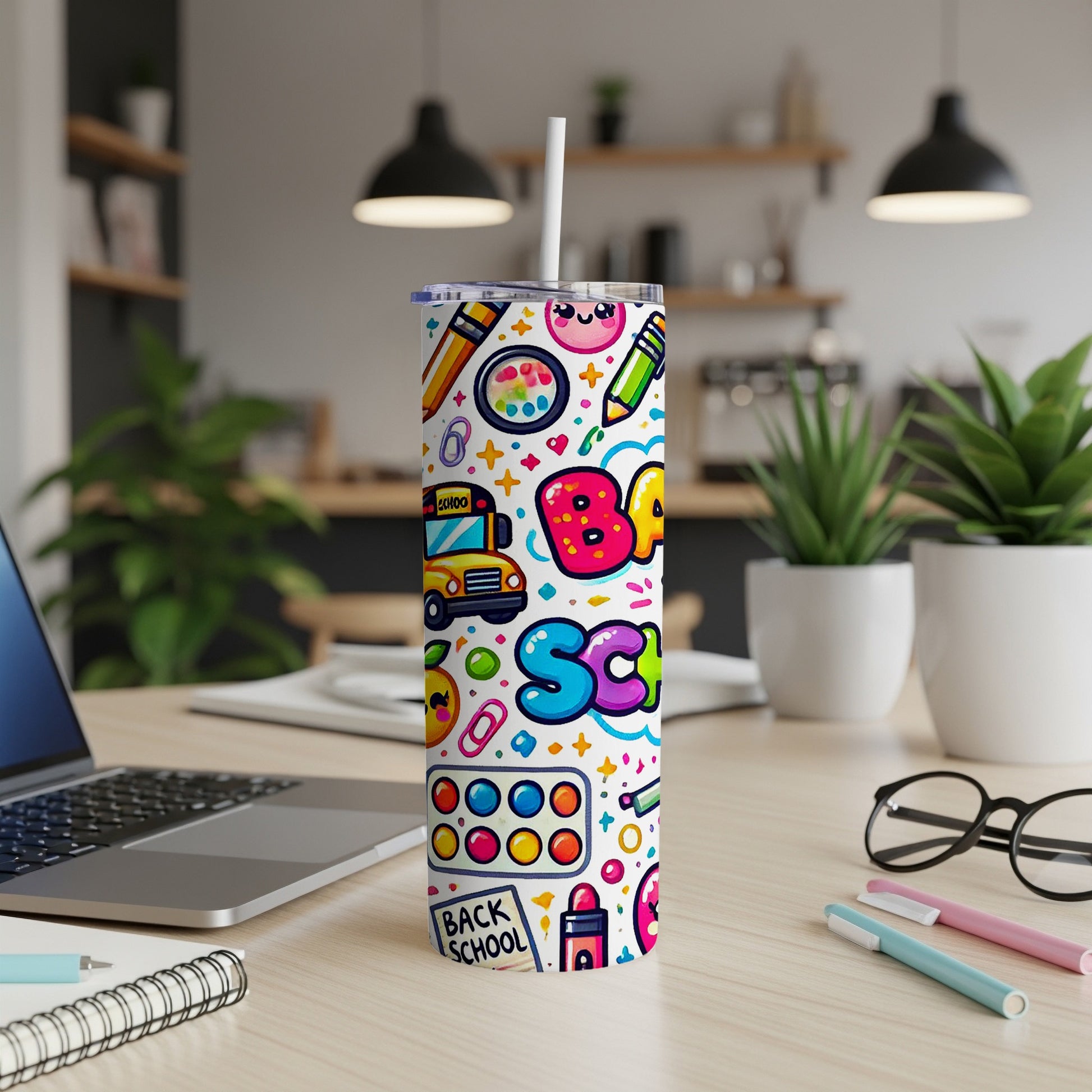 Tumbler with a colorful back-to-school design featuring a bus, pencils, and letters.