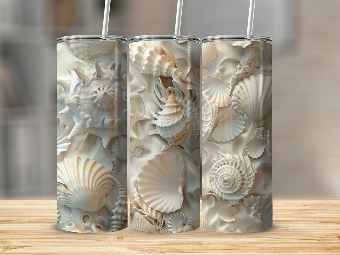 Triptych of tumblers with detailed seashell and sand art designs.
