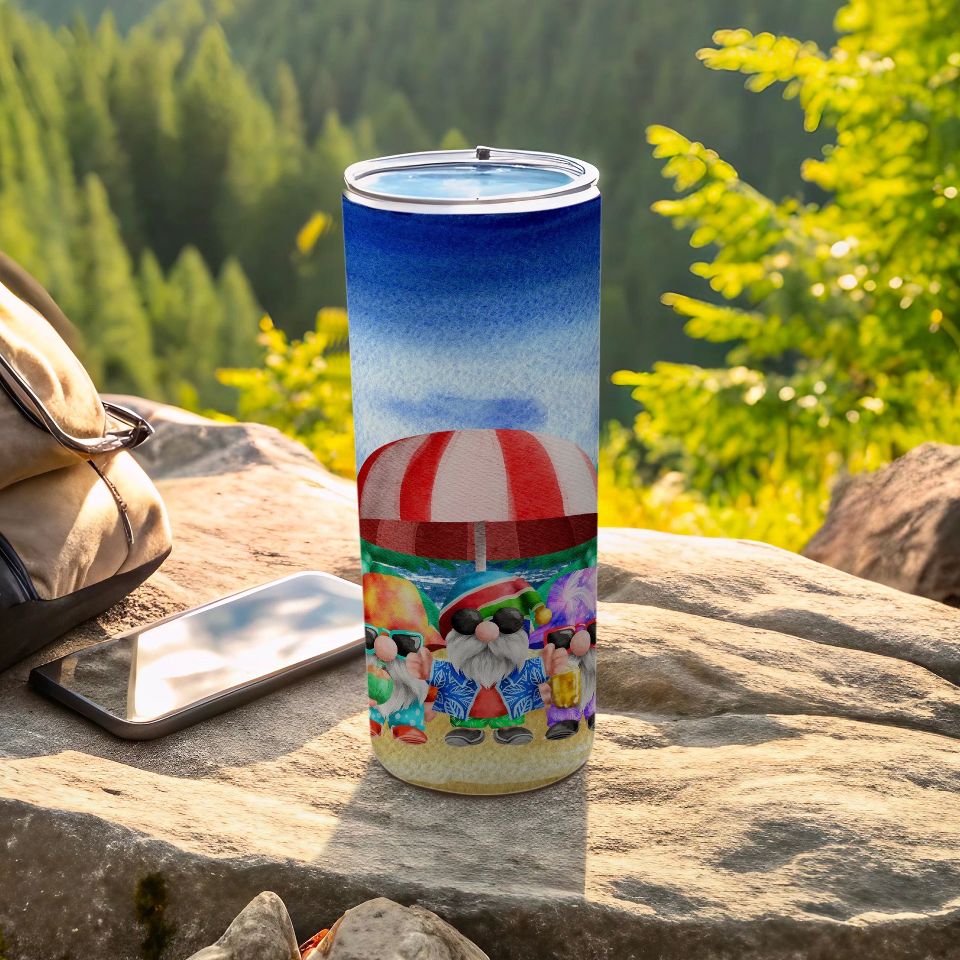 Beach-themed tumbler with gnomes under a striped umbrella.