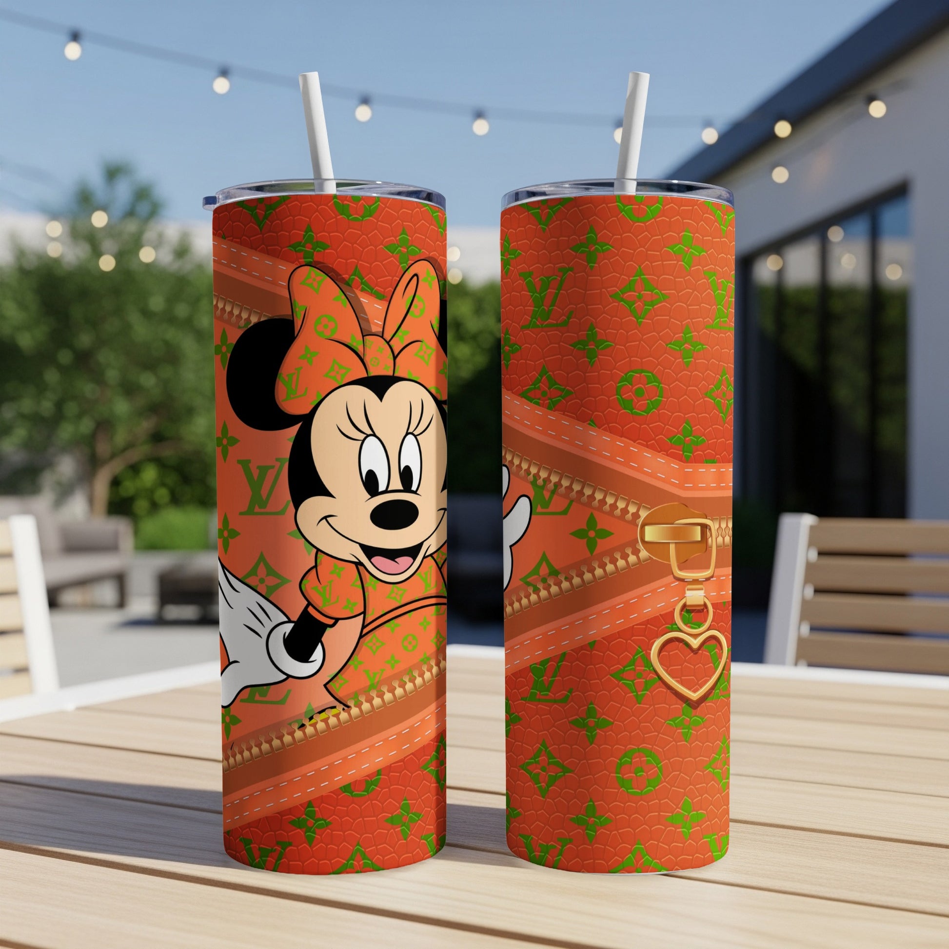 Minnie Mouse in orange designer print on tumbler with zipper detail.