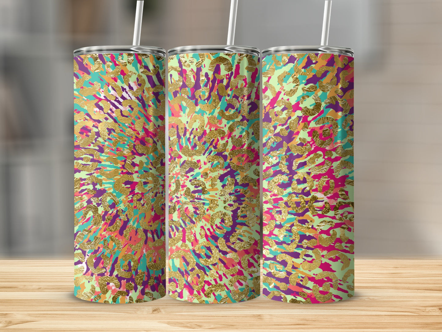 Three tumblers with a colorful abstract splatter pattern and gold leopard print accents.