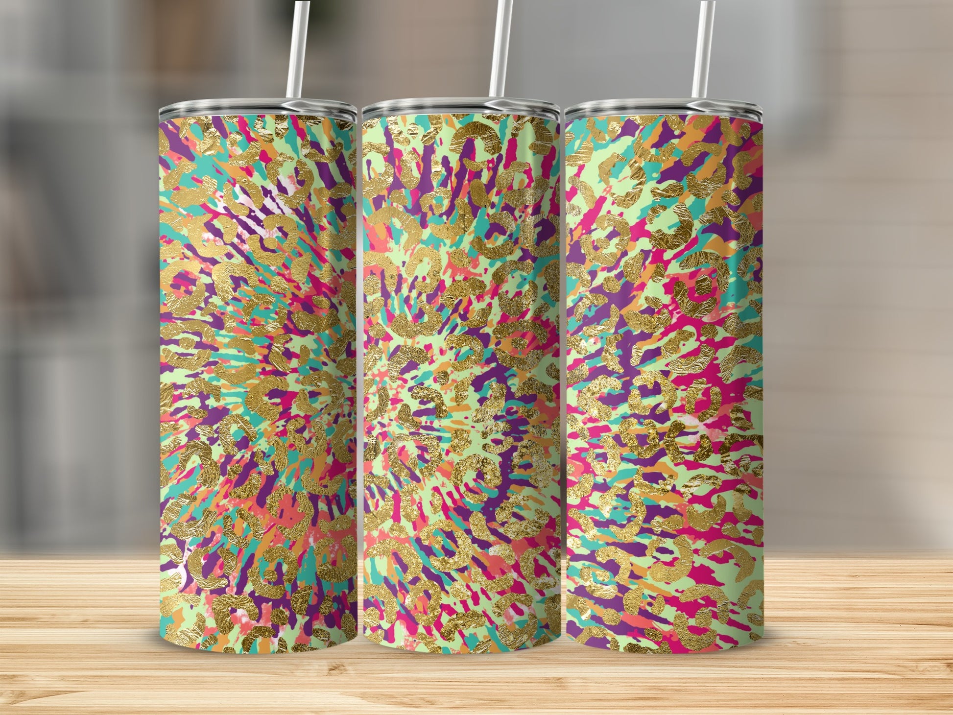 Three tumblers with a colorful abstract splatter pattern and gold leopard print accents.