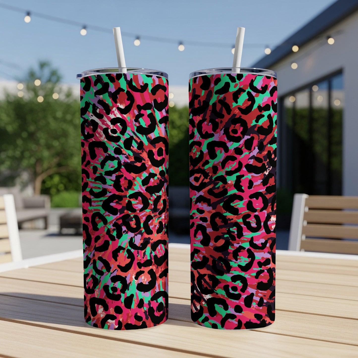 Two tumblers with a vibrant pink, black, and teal abstract leopard print pattern.