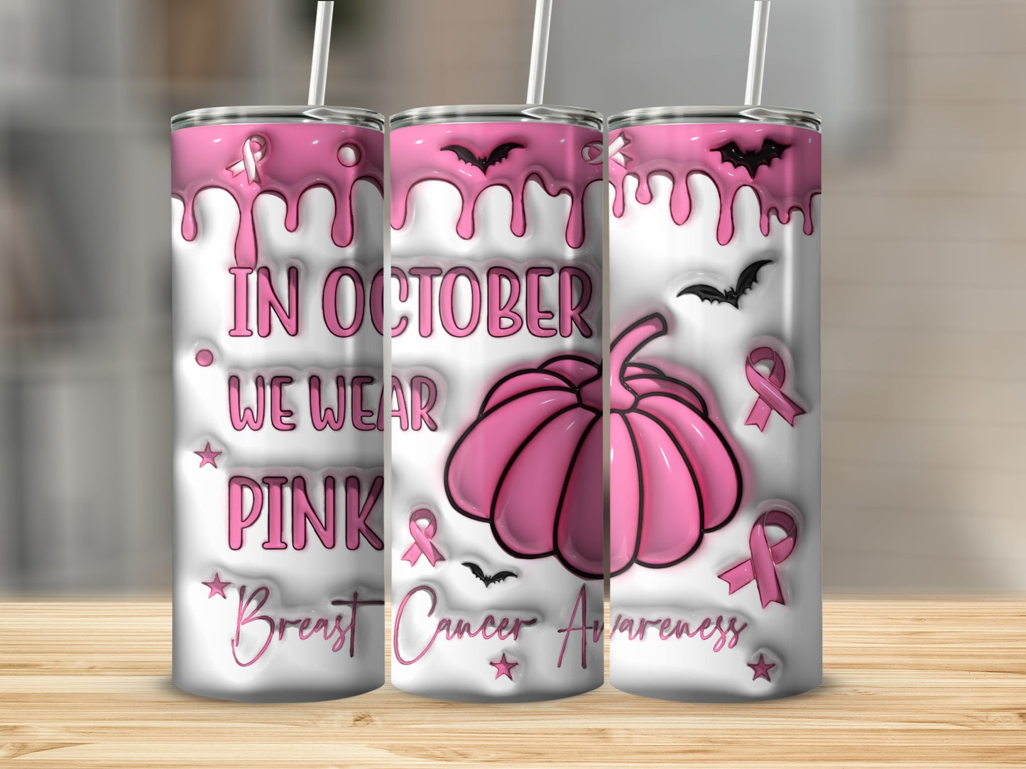 Pink tumbler with bats, pumpkin, and "In October We Wear Pink" text.