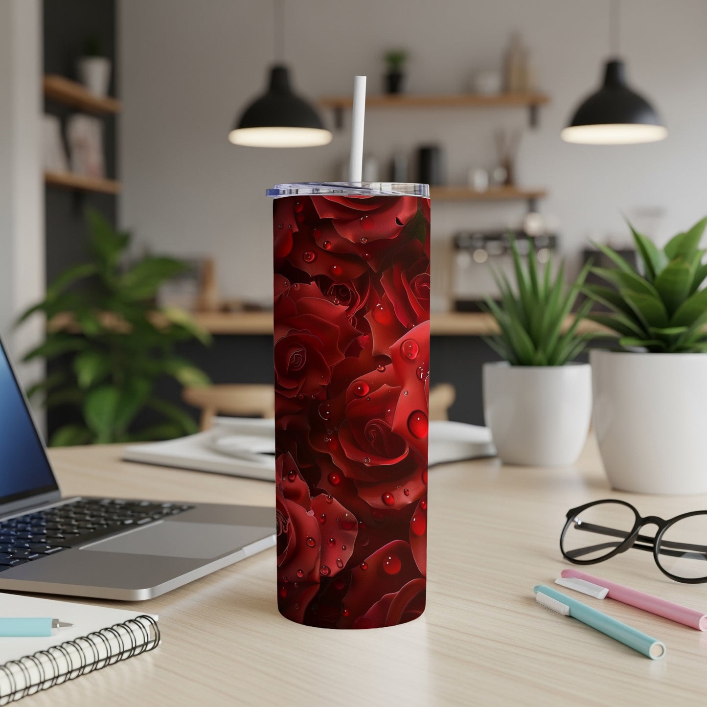 Red roses with water droplets on a white tumbler with a straw.