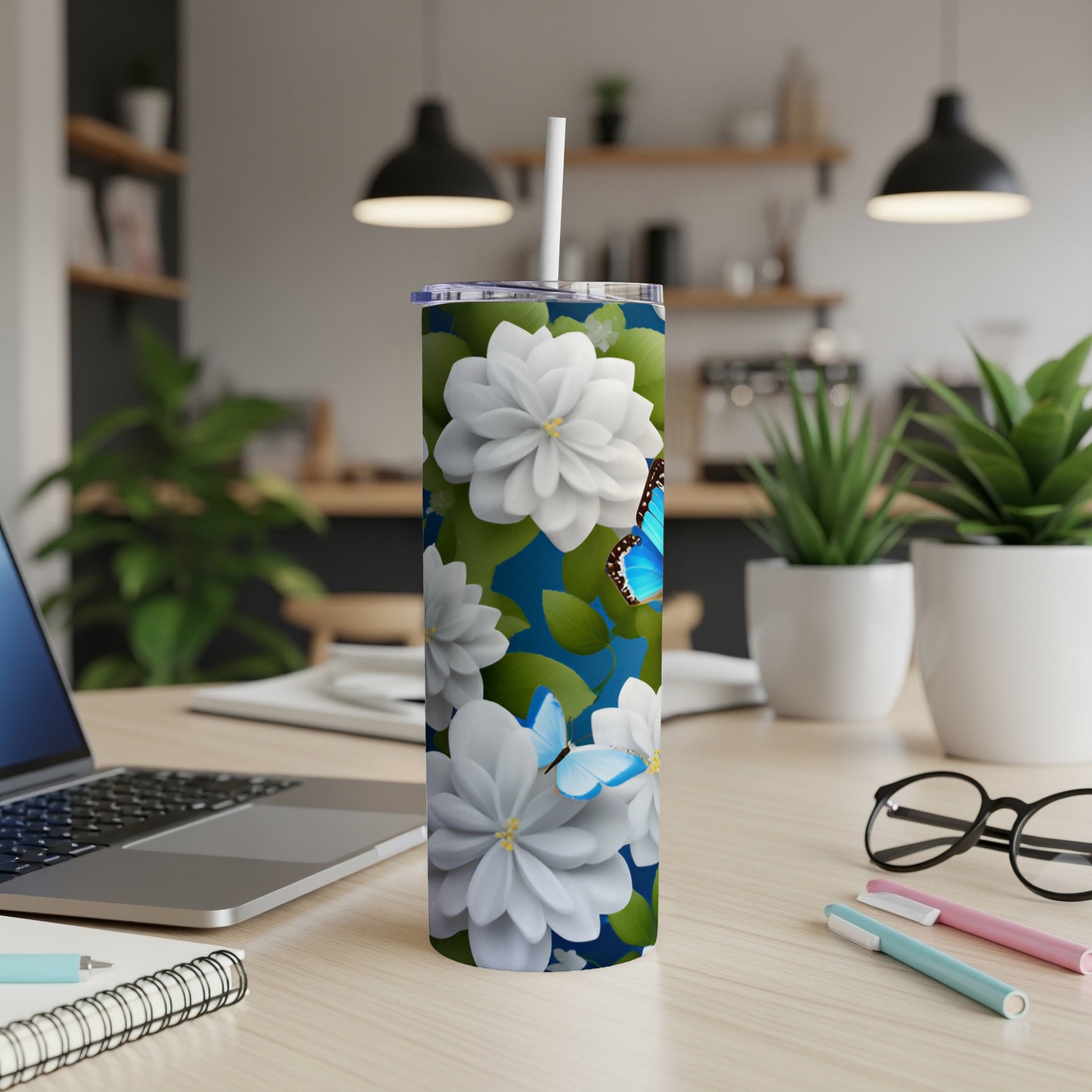 White and blue floral design with butterflies on a tumbler.