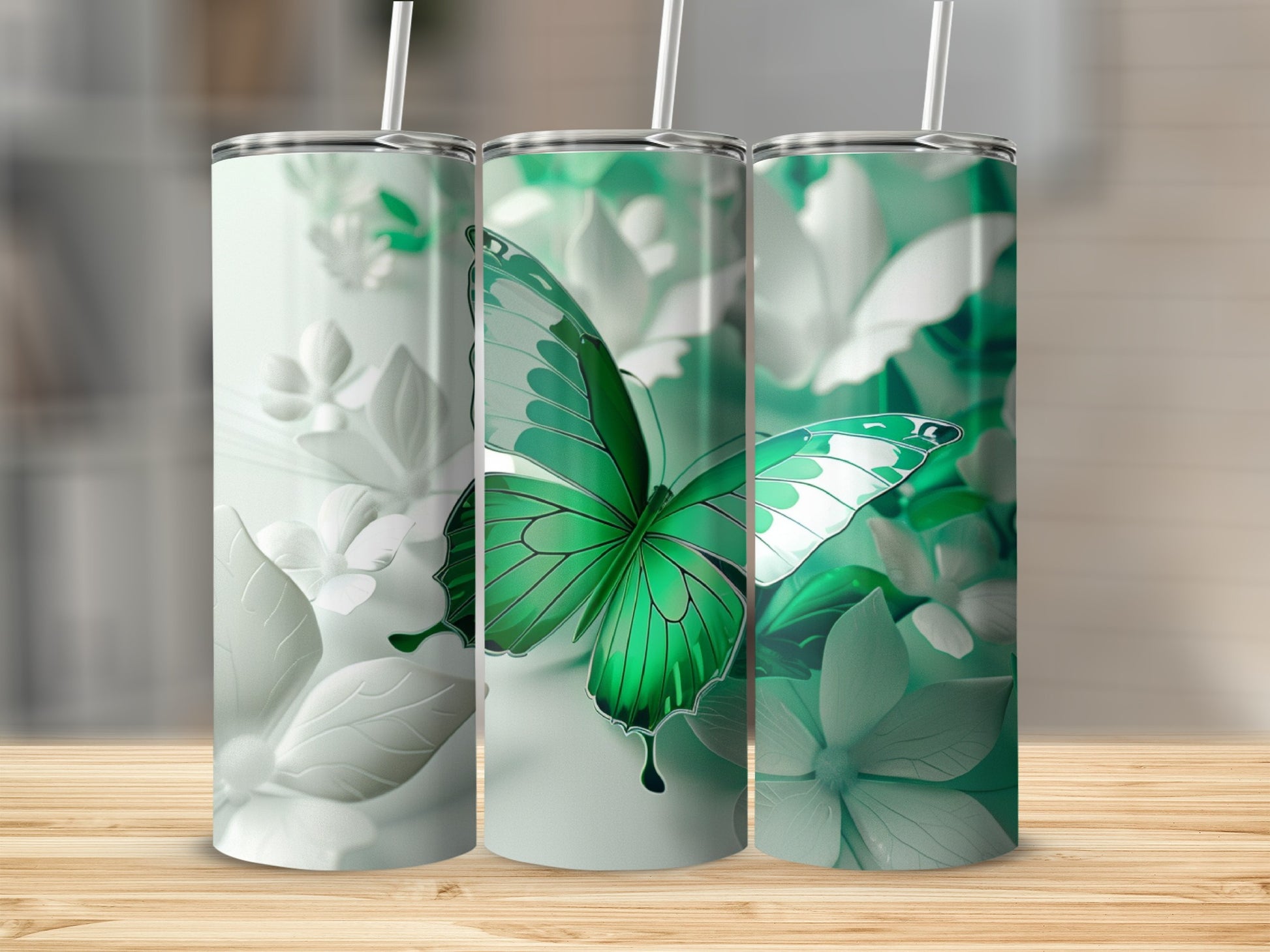 Three tumblers with green butterfly and floral designs.