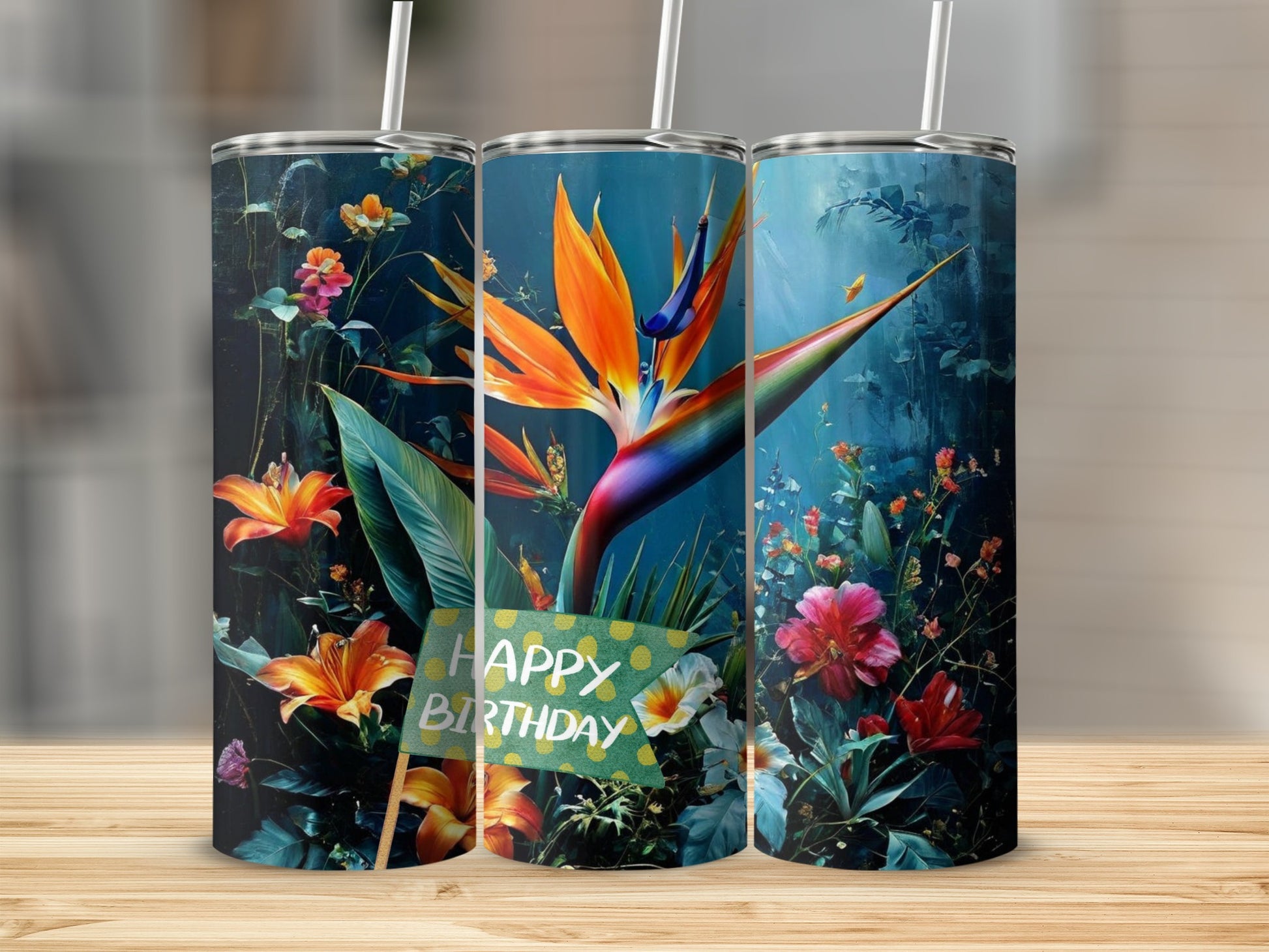 Three tumblers with bird of paradise and floral designs, one with "Happy Birthday" sign.