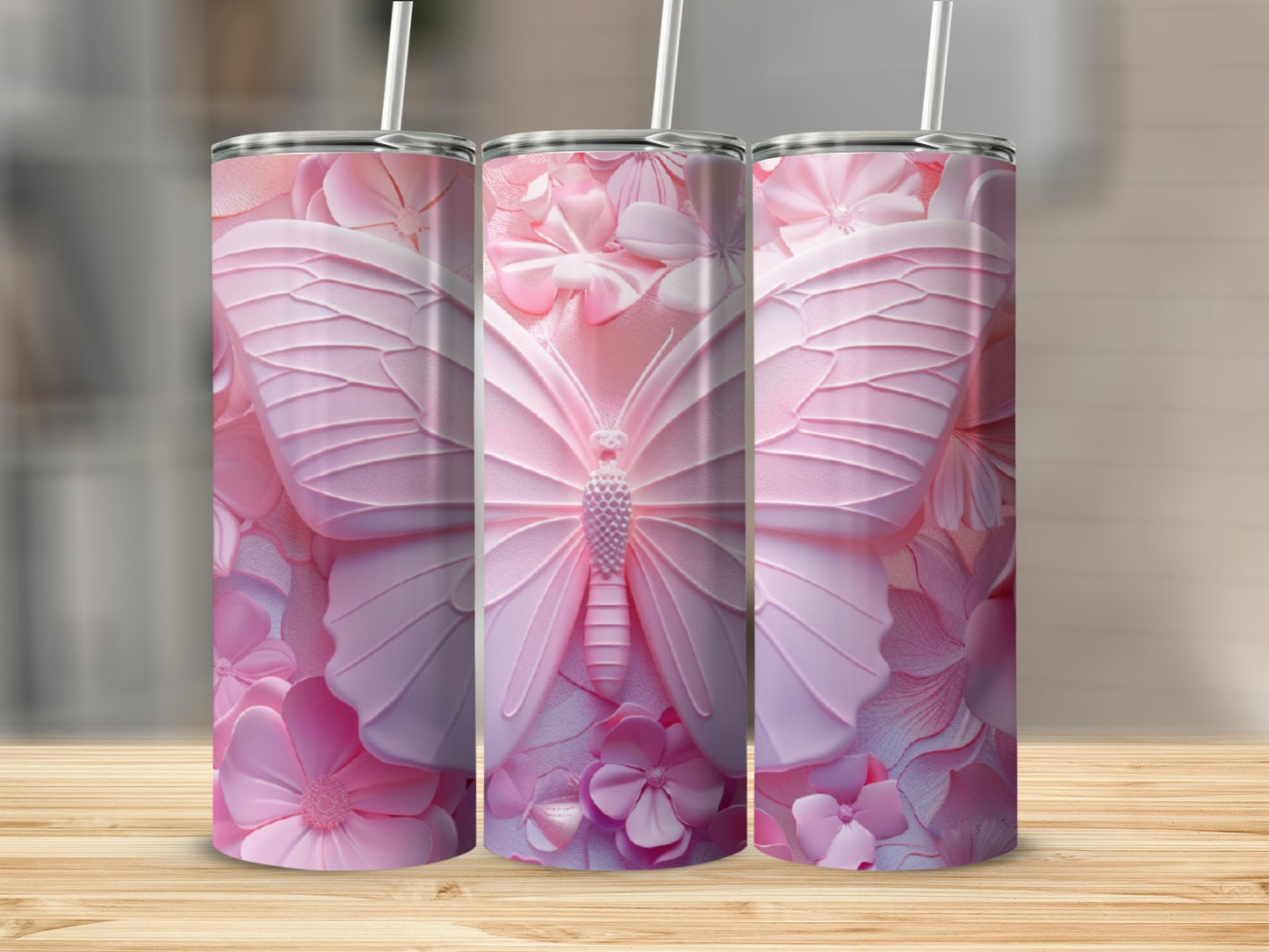 Pink butterfly and floral pattern on three tumblers.