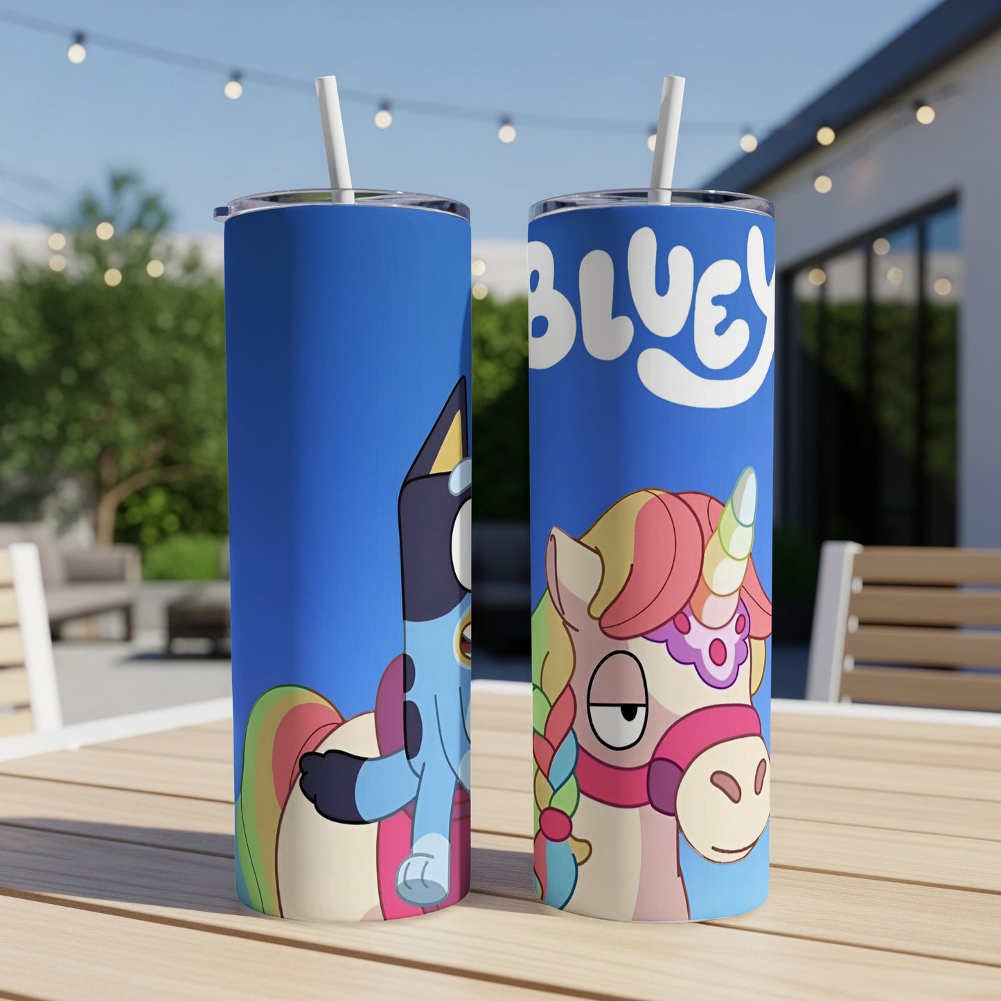 Bluey and Bingo characters on a blue tumbler with a cartoon unicorn.