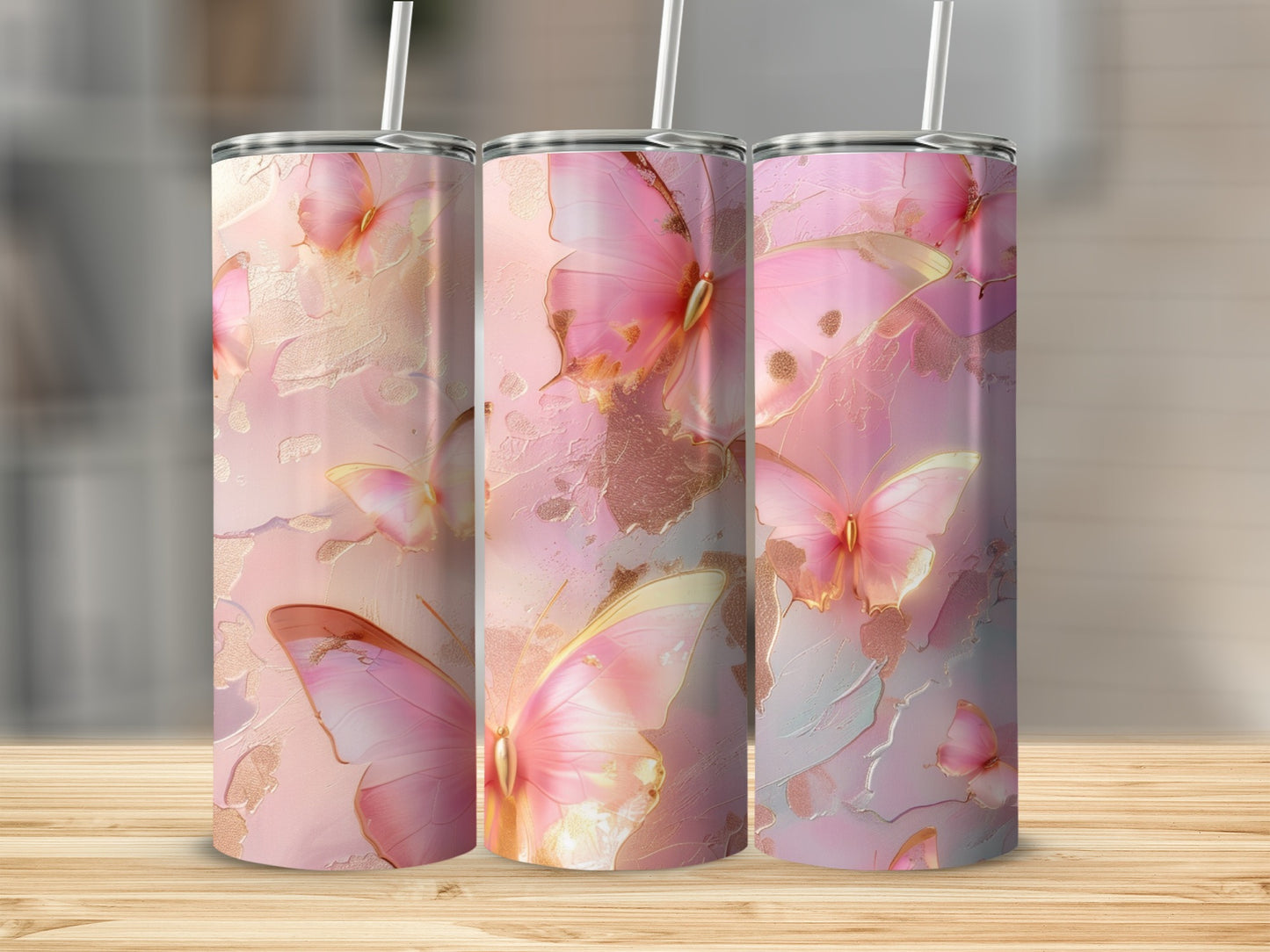 Pink butterflies and gold accents on three tumblers.