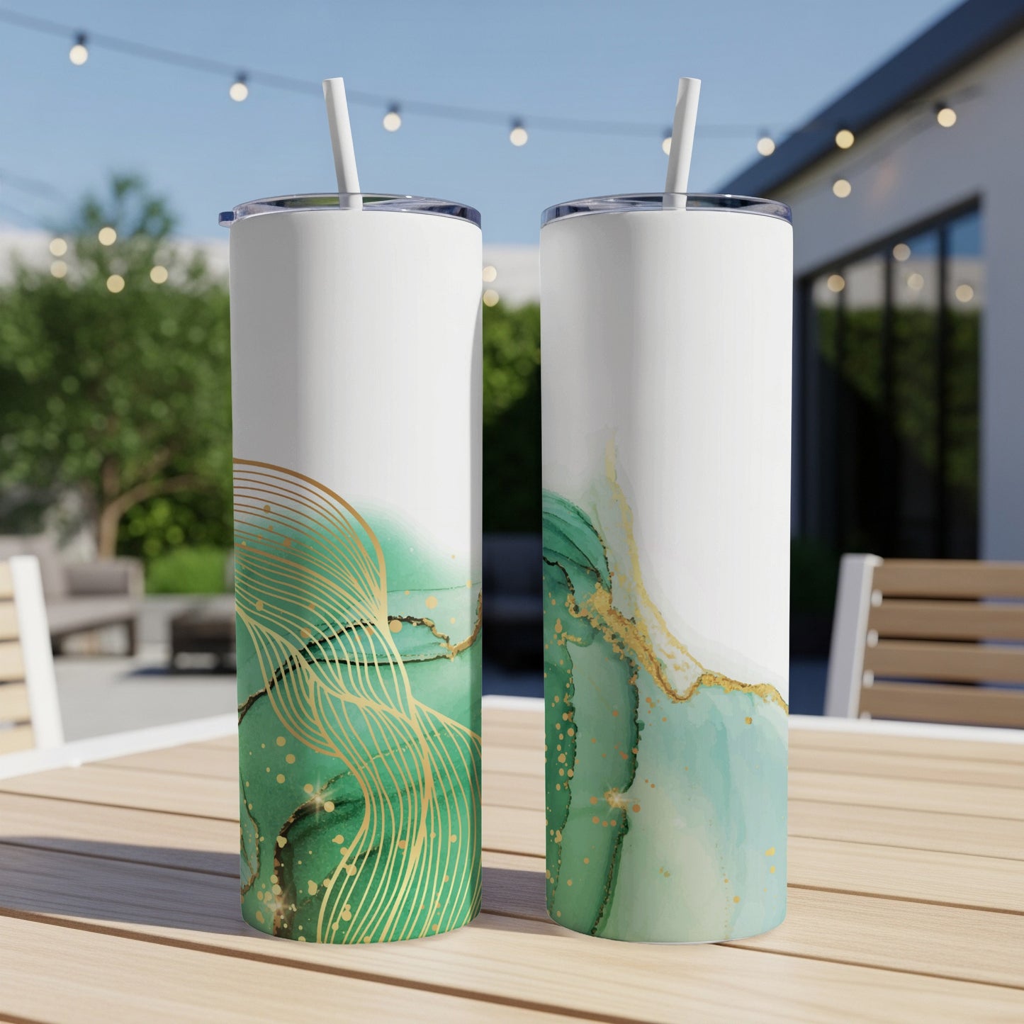 Two white tumblers with abstract green and gold marbling designs.