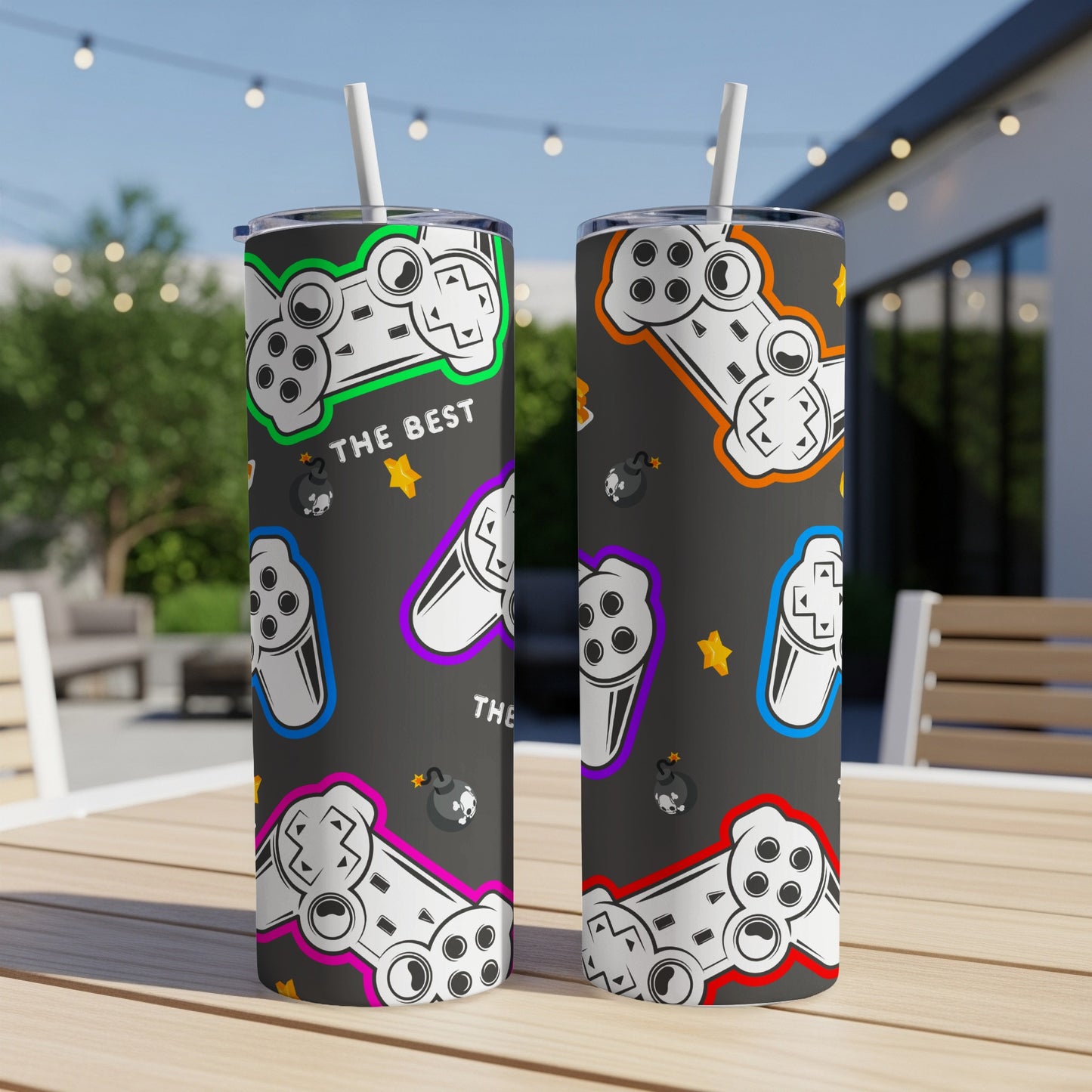 Two tumblers with video game controllers, bombs, and stars pattern.