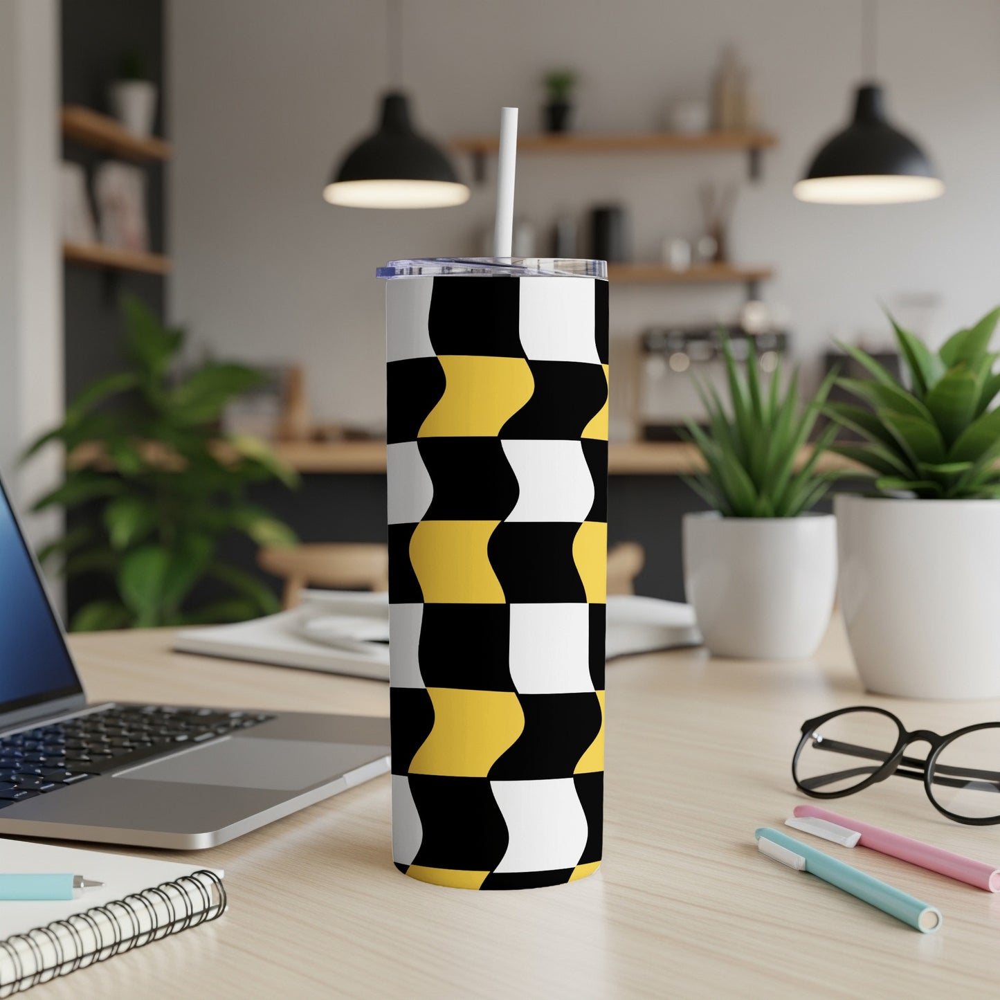 Black, white, and yellow wavy checkerboard pattern tumbler with straw.