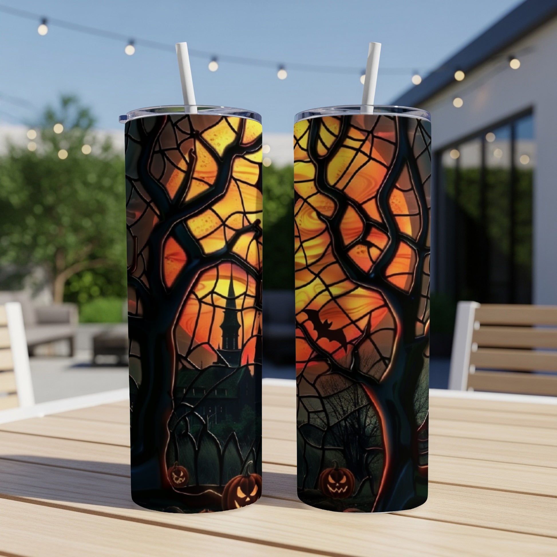 Two Halloween-themed tumblers with jack-o'-lanterns and a haunted house design.