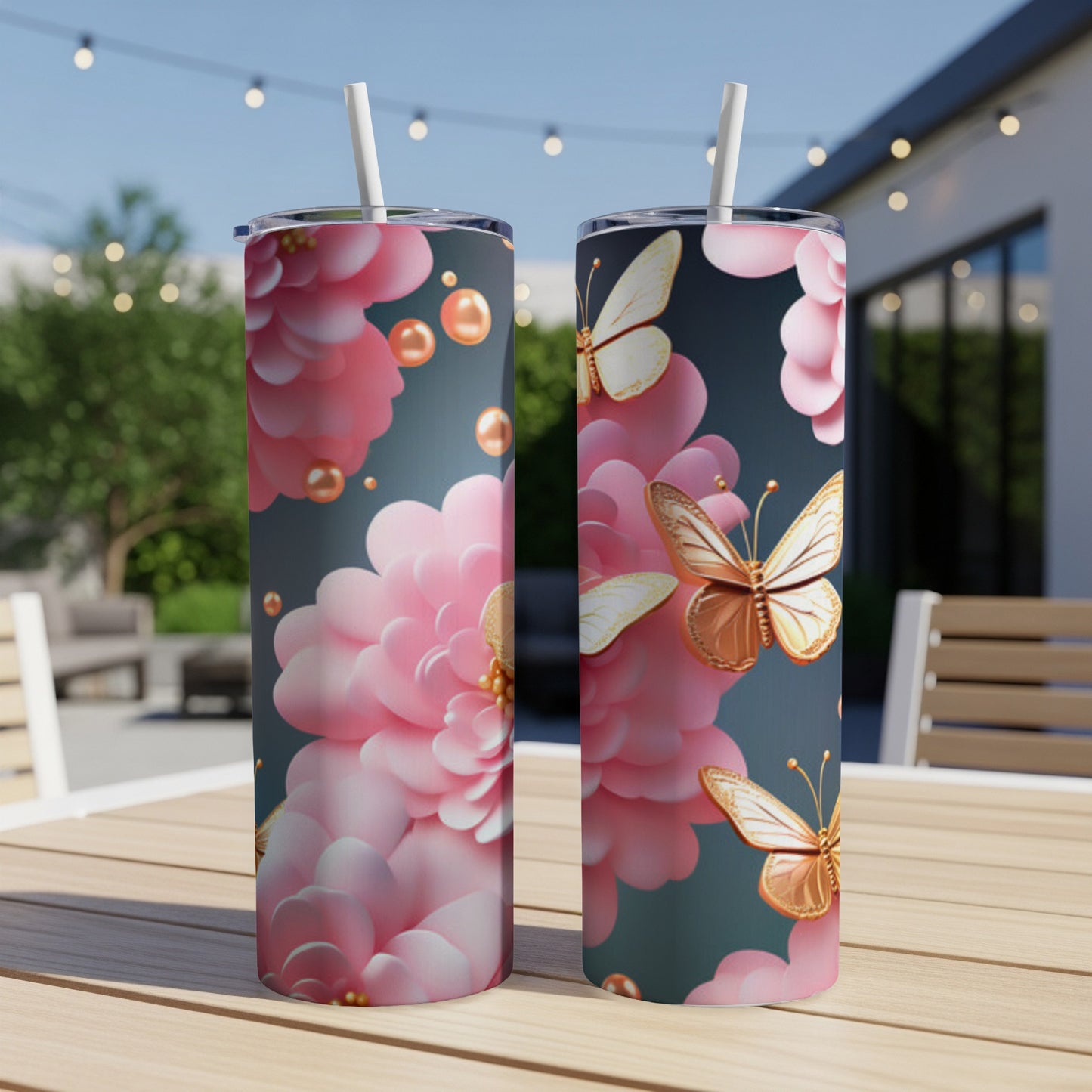 Two tumblers with pink floral and butterfly design sit on a table.
