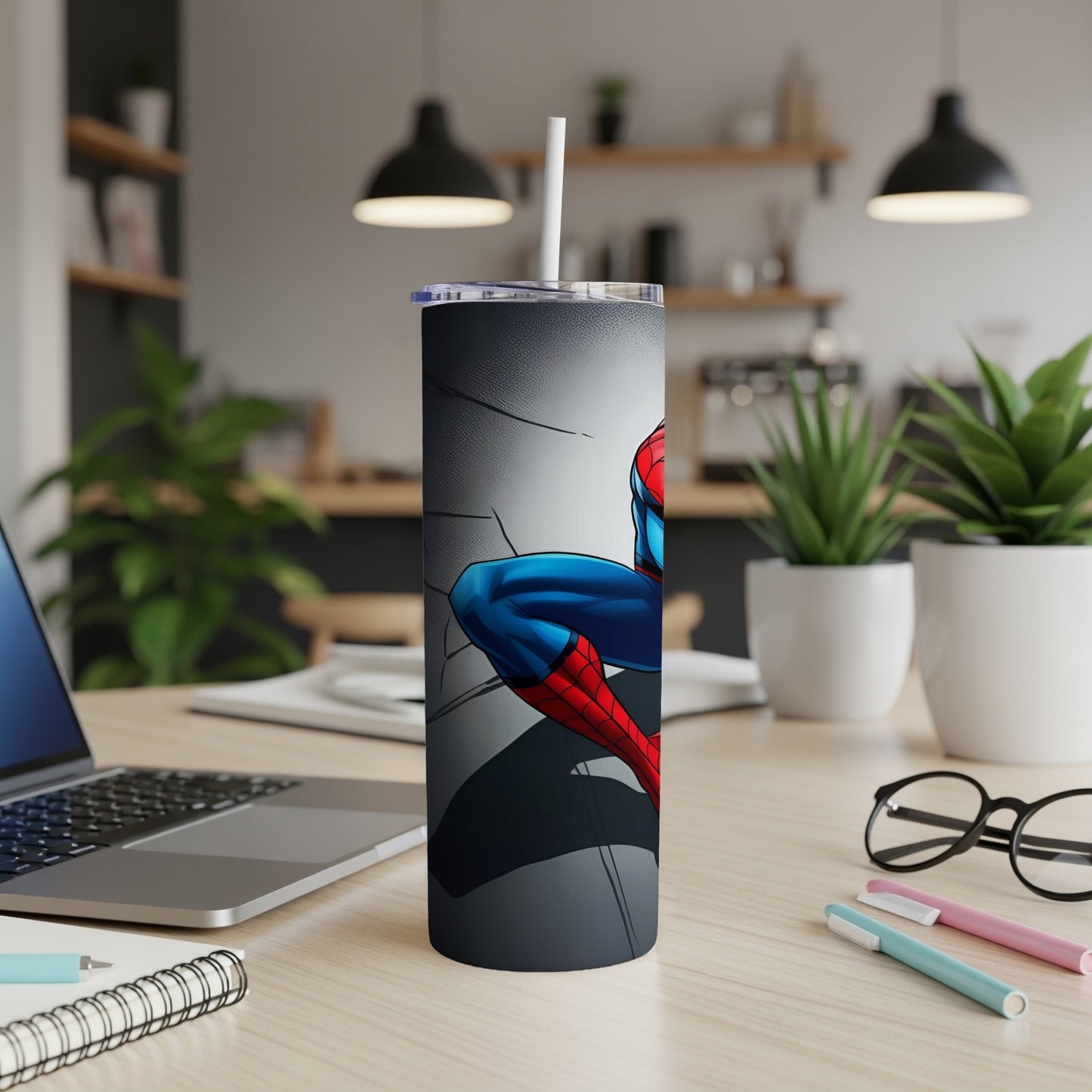 Spider-Man leaning forward on a gray tumbler with a straw.