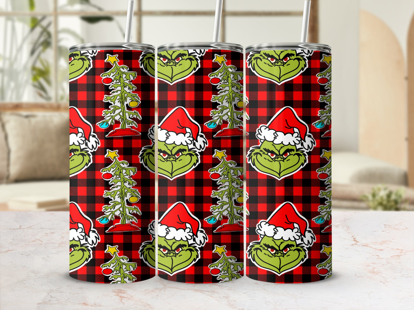 Grinch design on red plaid tumbler with Christmas tree.