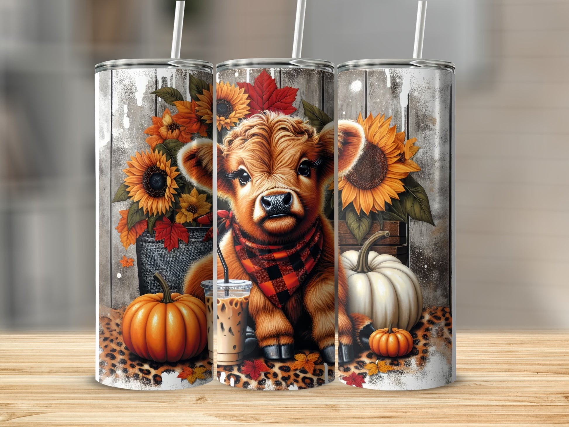 Cute cow with plaid scarf and fall decorations on a tumbler.