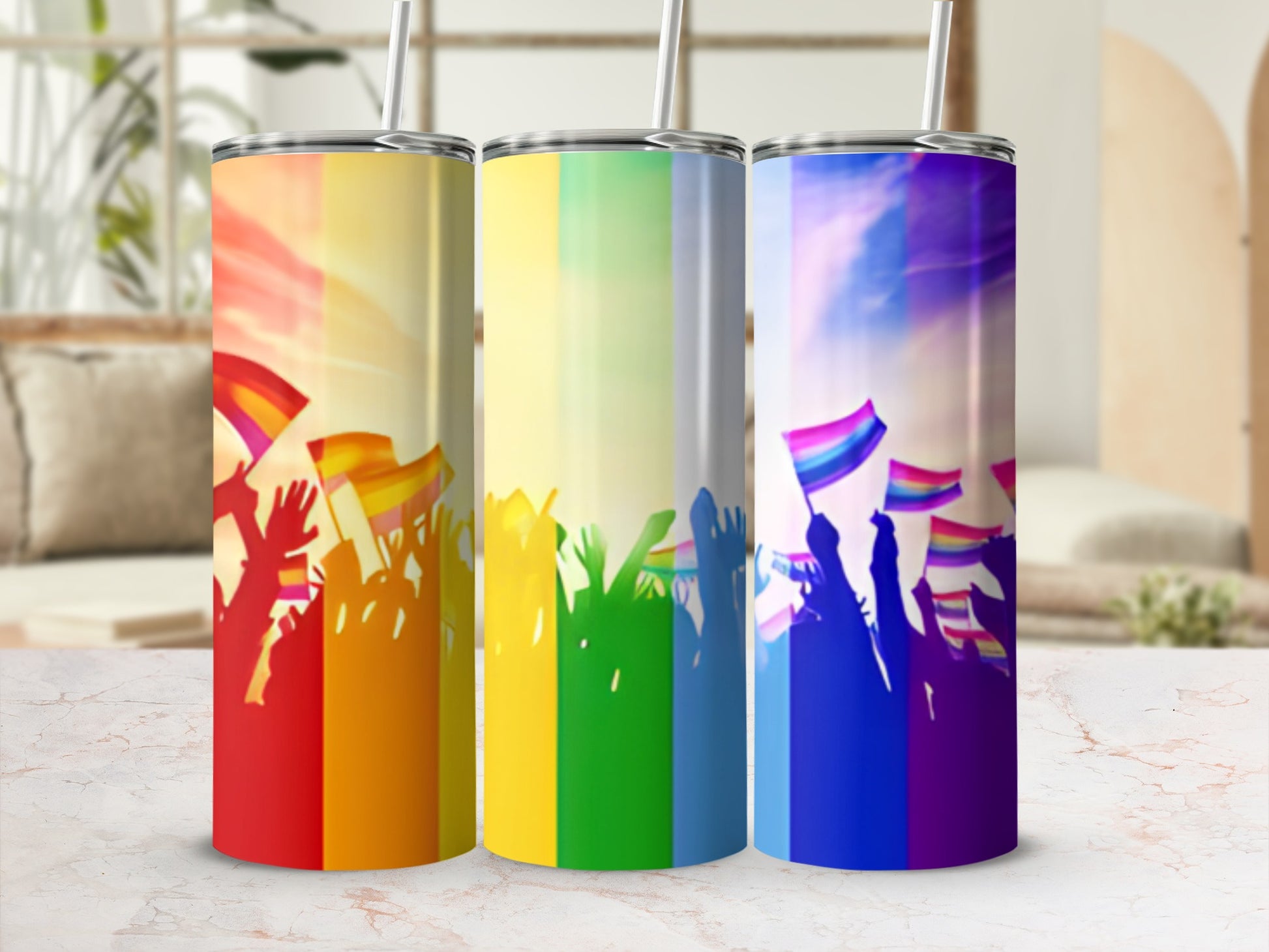 Three tumblers with rainbow or pride flag designs and crowd silhouettes.