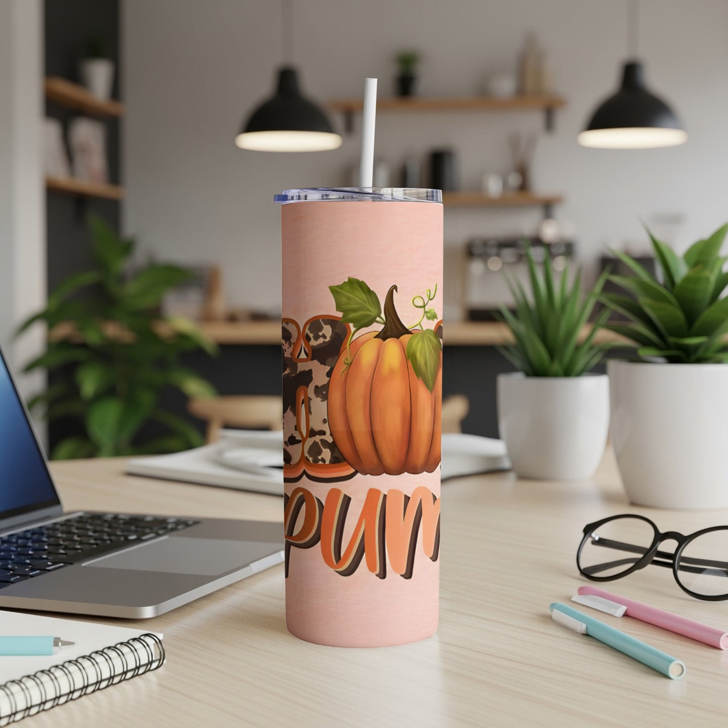Pink tumbler with pumpkin and leopard print design, straw visible.
