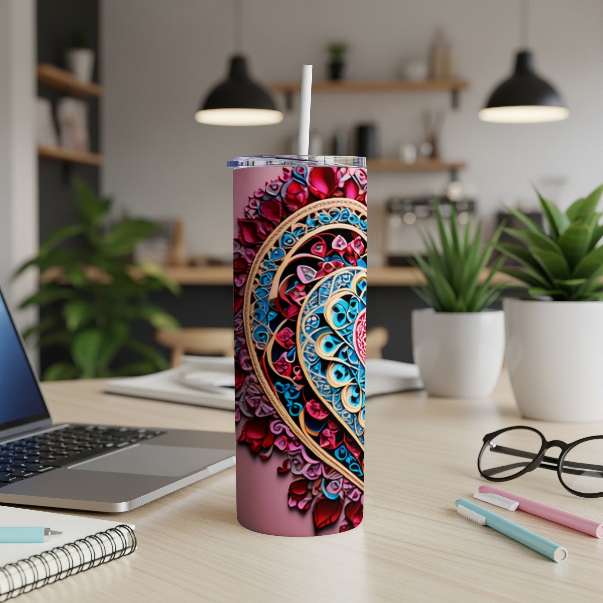 Pink tumbler with colorful mandala design and white straw.