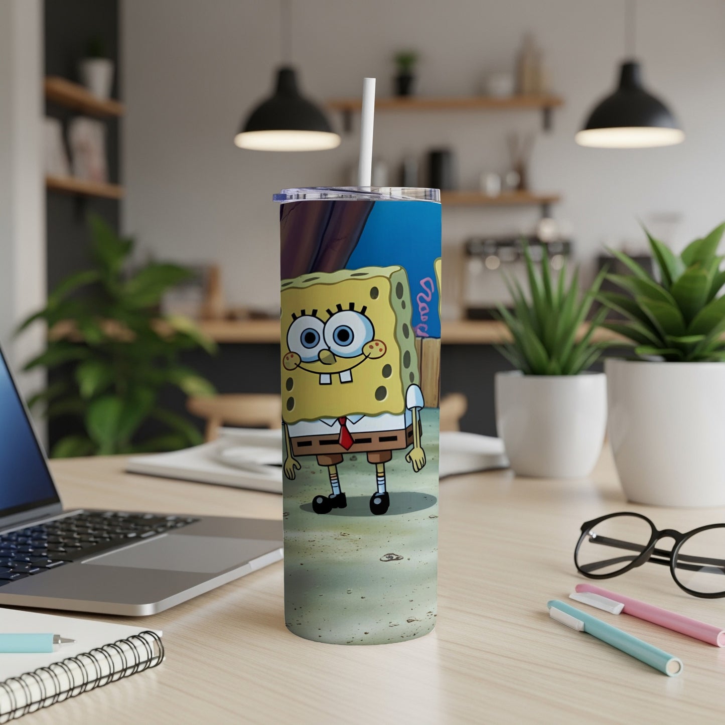 SpongeBob SquarePants character on a stainless steel tumbler with a white straw.