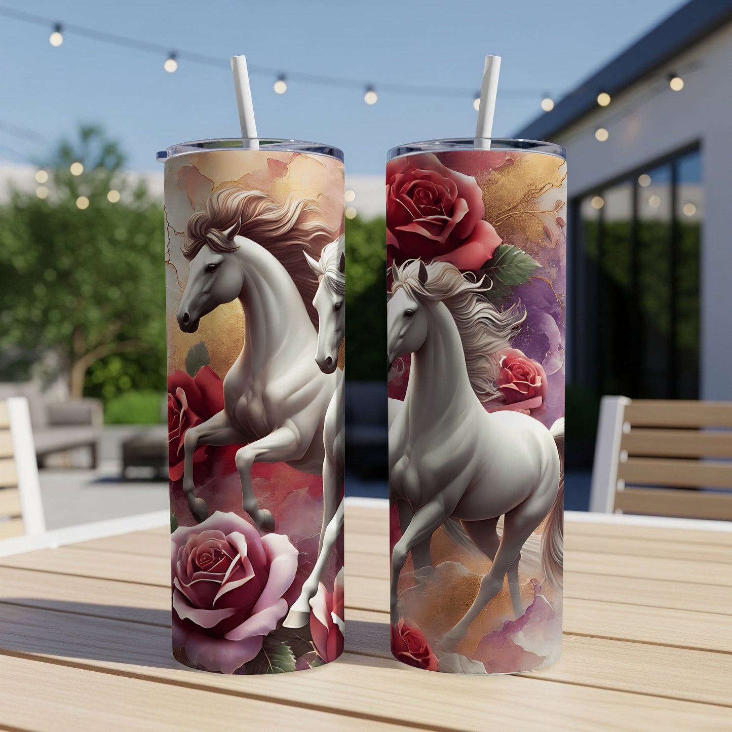 Two tumblers featuring white horses and red roses on a patio table.