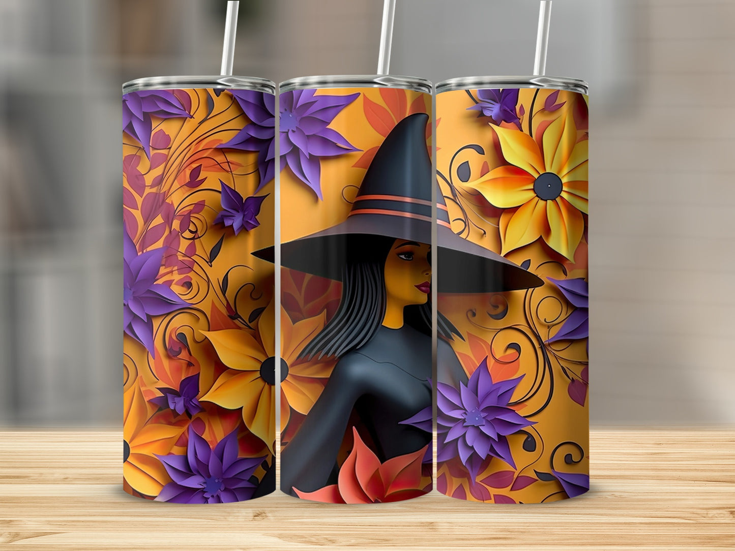 Three tumblers with a witch and floral design, featuring orange, yellow, and purple flowers.