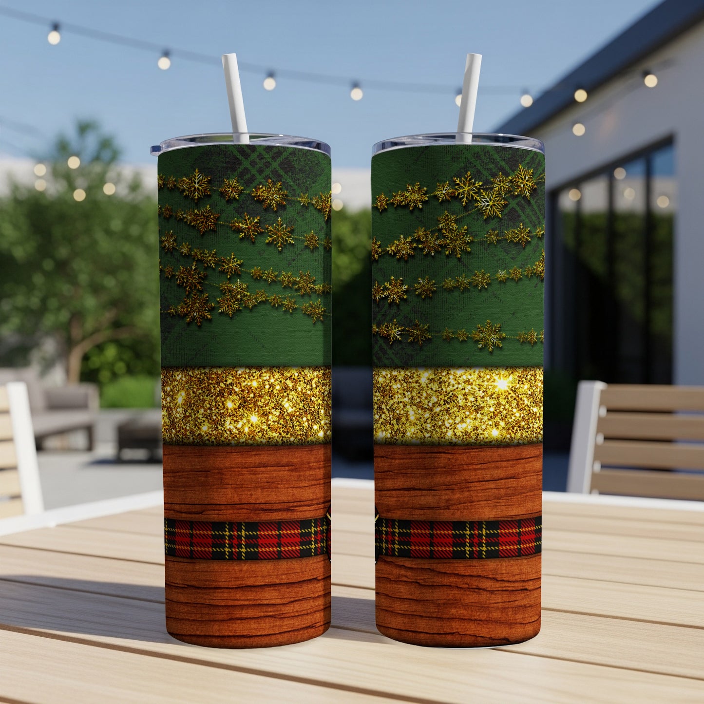 Two tumblers with green, gold glitter, and plaid designs on a table.