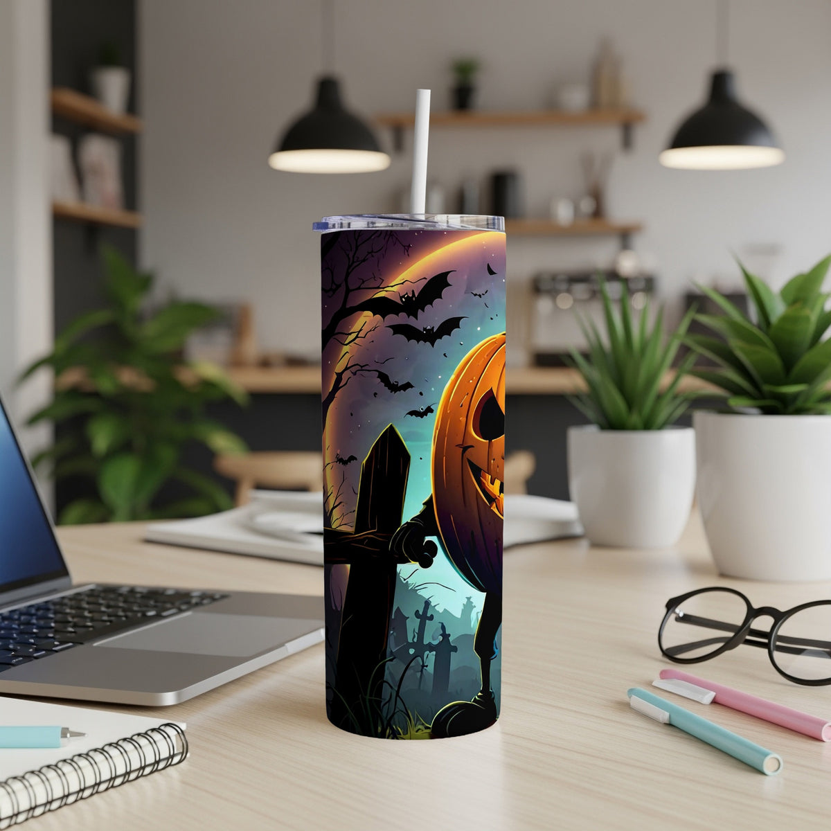 Tumbler with a Halloween graveyard and pumpkin design, featuring bats and a moon.