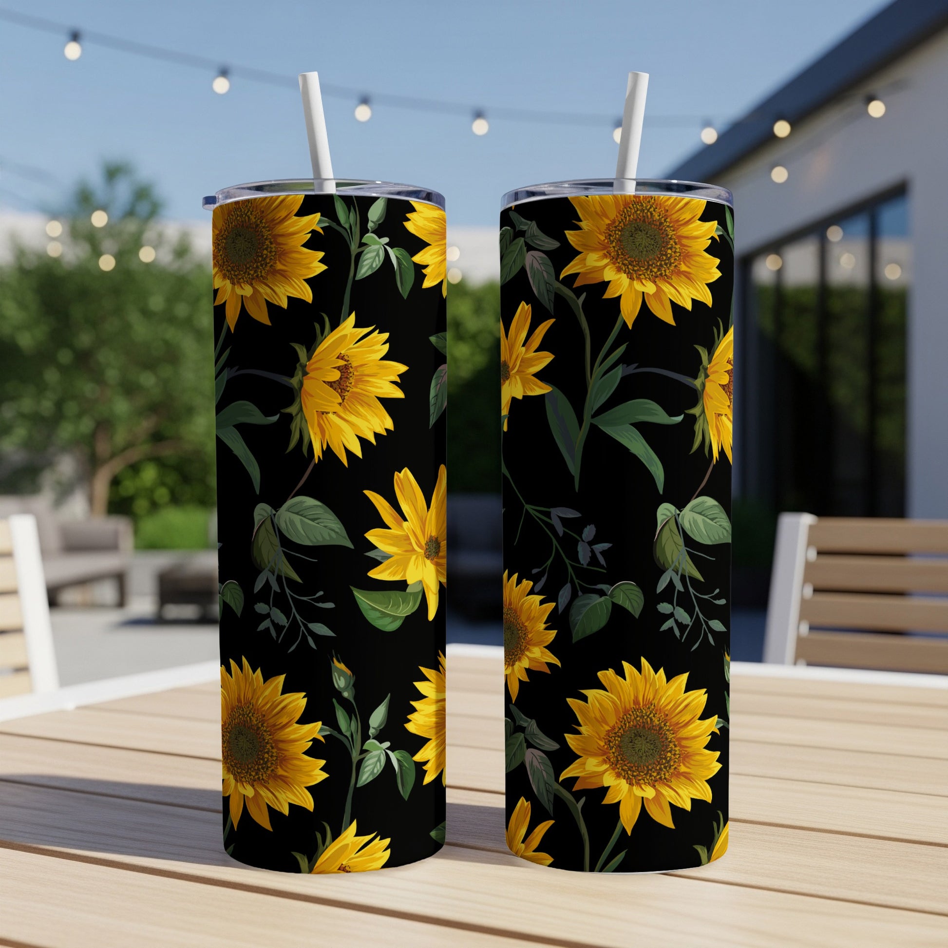 Two tumblers with a black background and a repeating sunflower and leaf pattern.