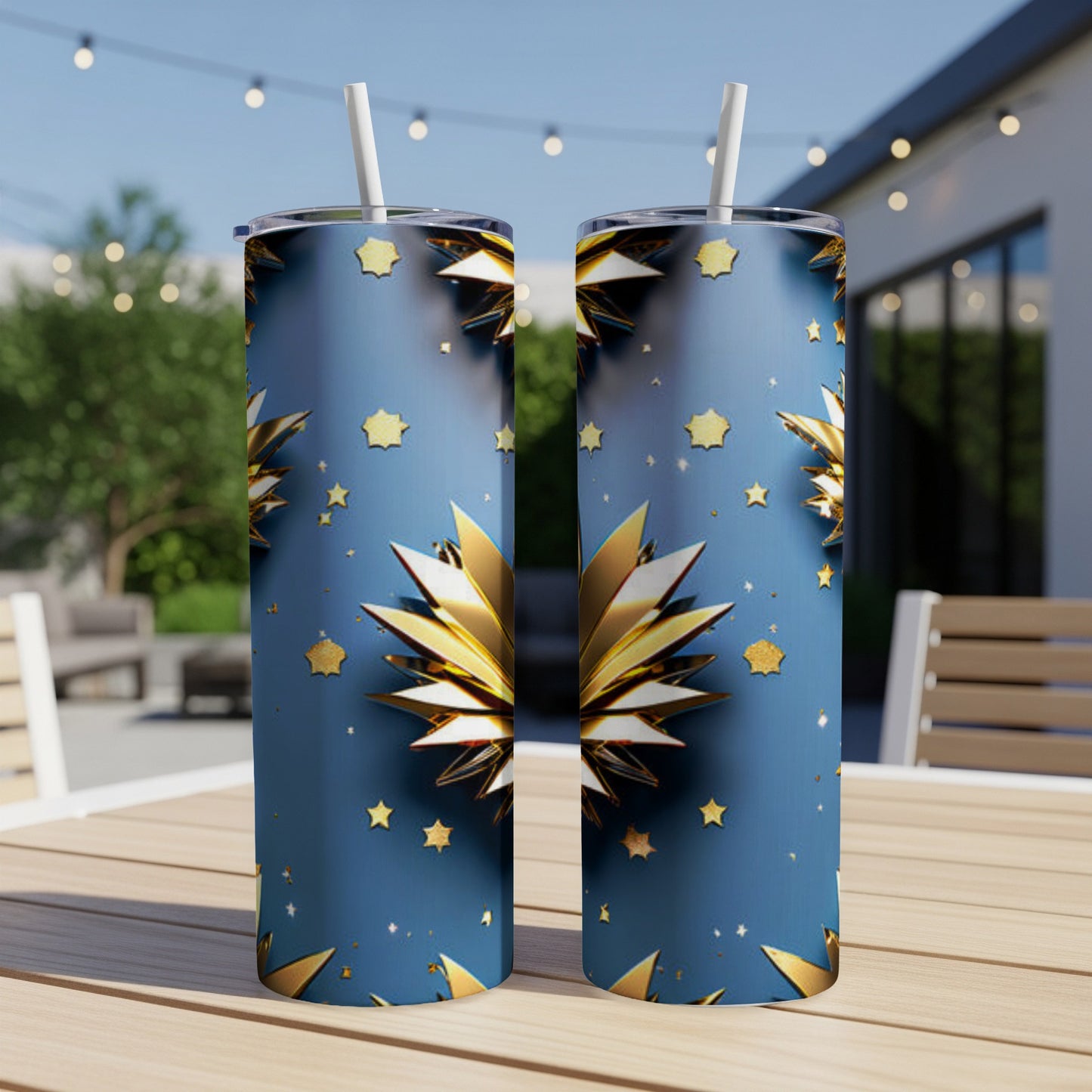 Two blue tumblers with gold star and bloom pattern on a wooden table.