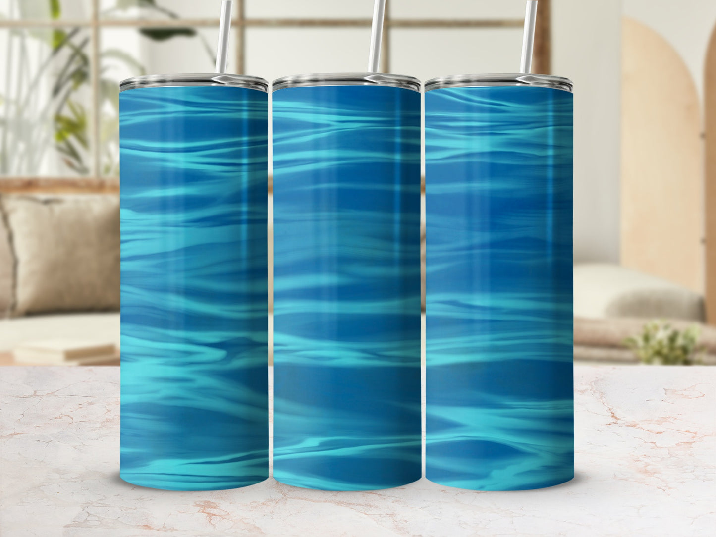 Three tall tumblers with rippling blue water pattern and straws.