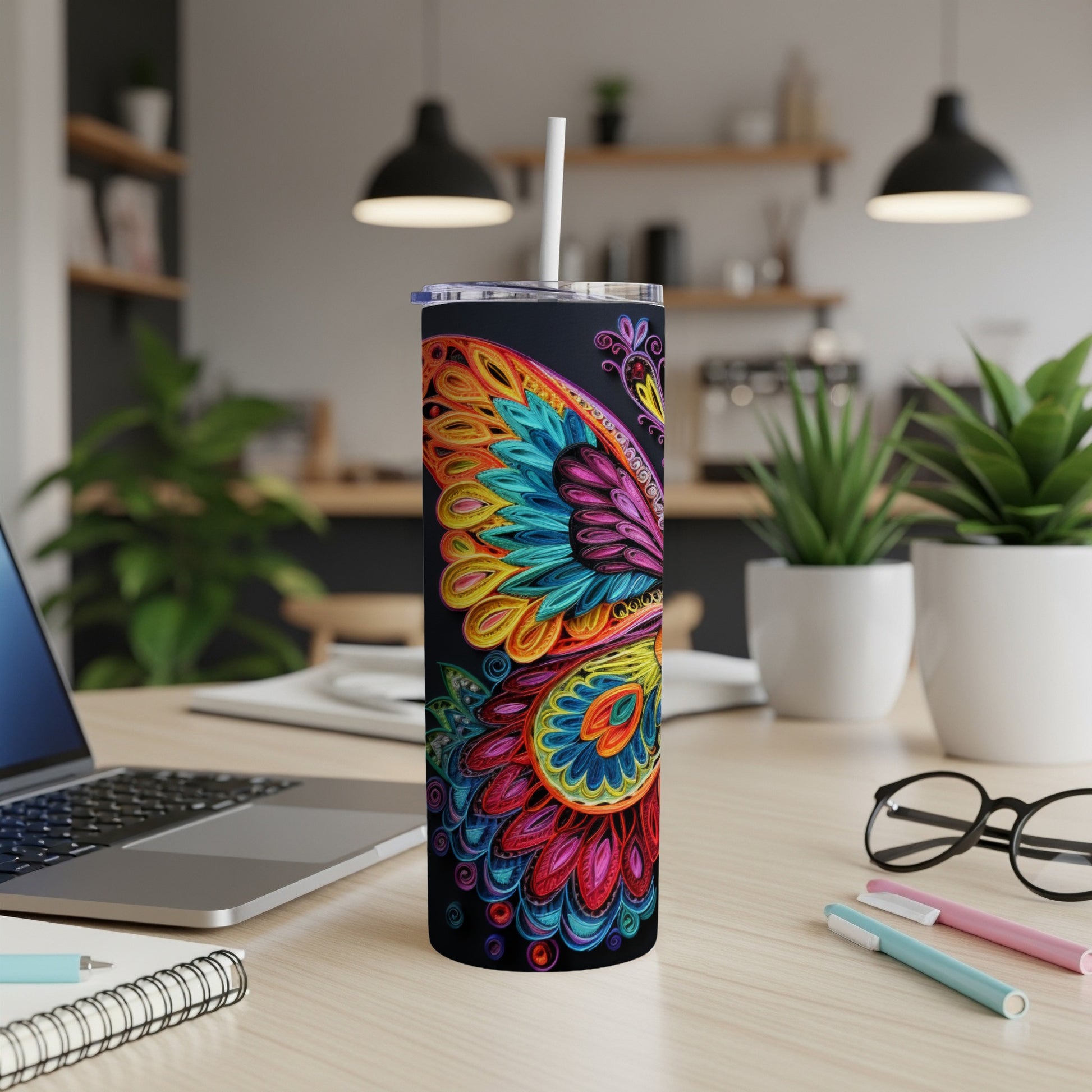 Colorful butterfly design on a black skinny tumbler with straw.