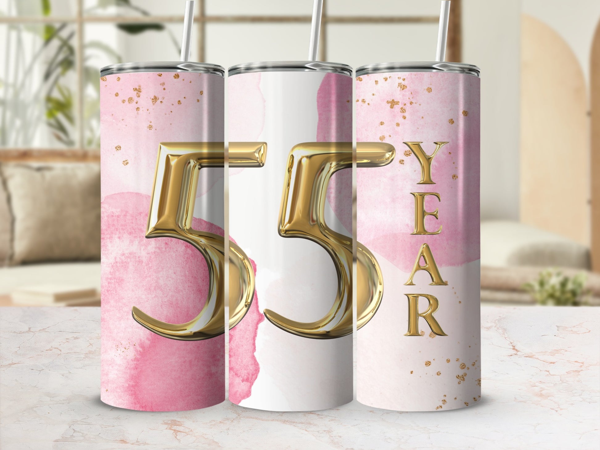 Gold "55 YEAR" text on pink watercolor tumblers with gold speckles.