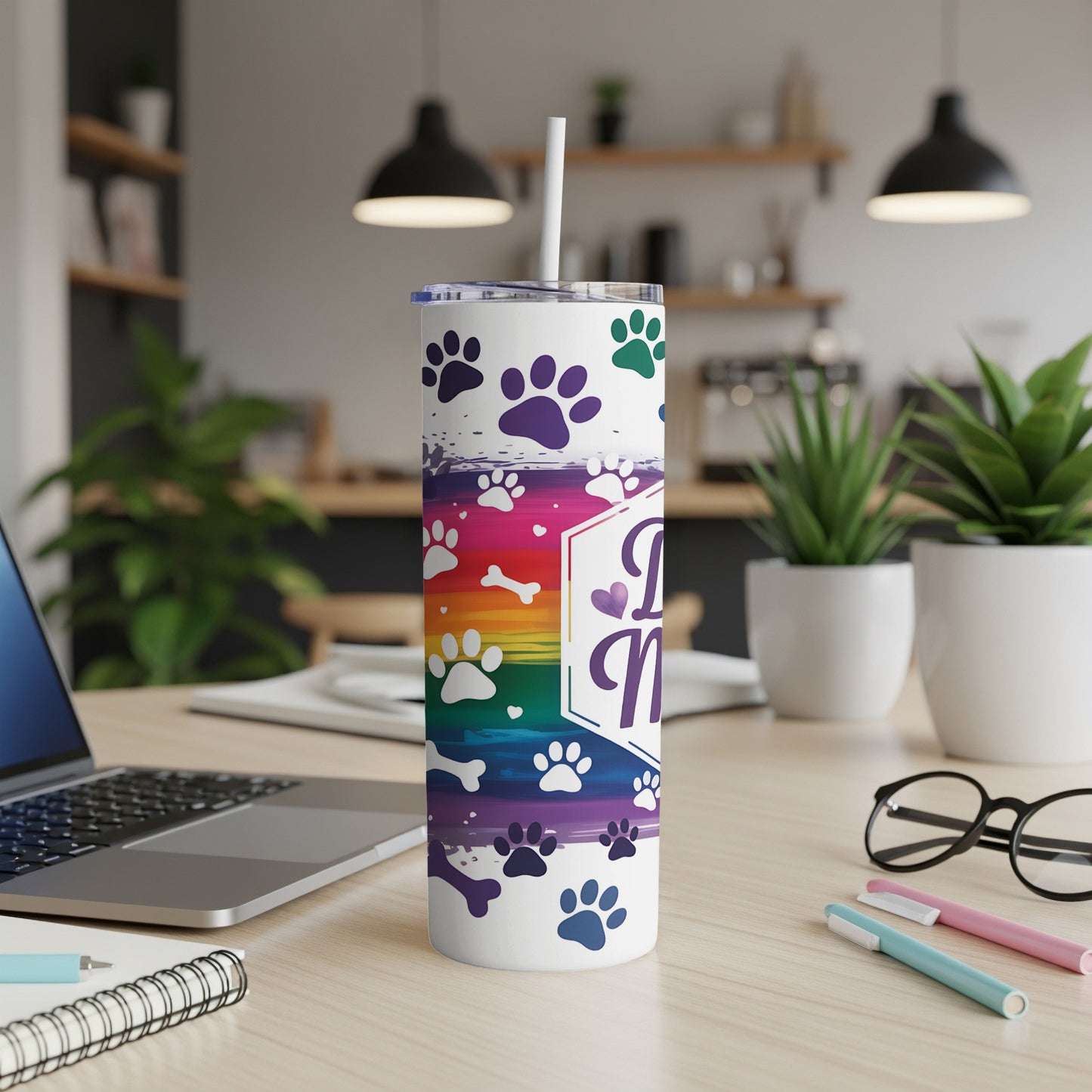 White tumbler with paw prints and rainbow background, "Dog Mom" text.
