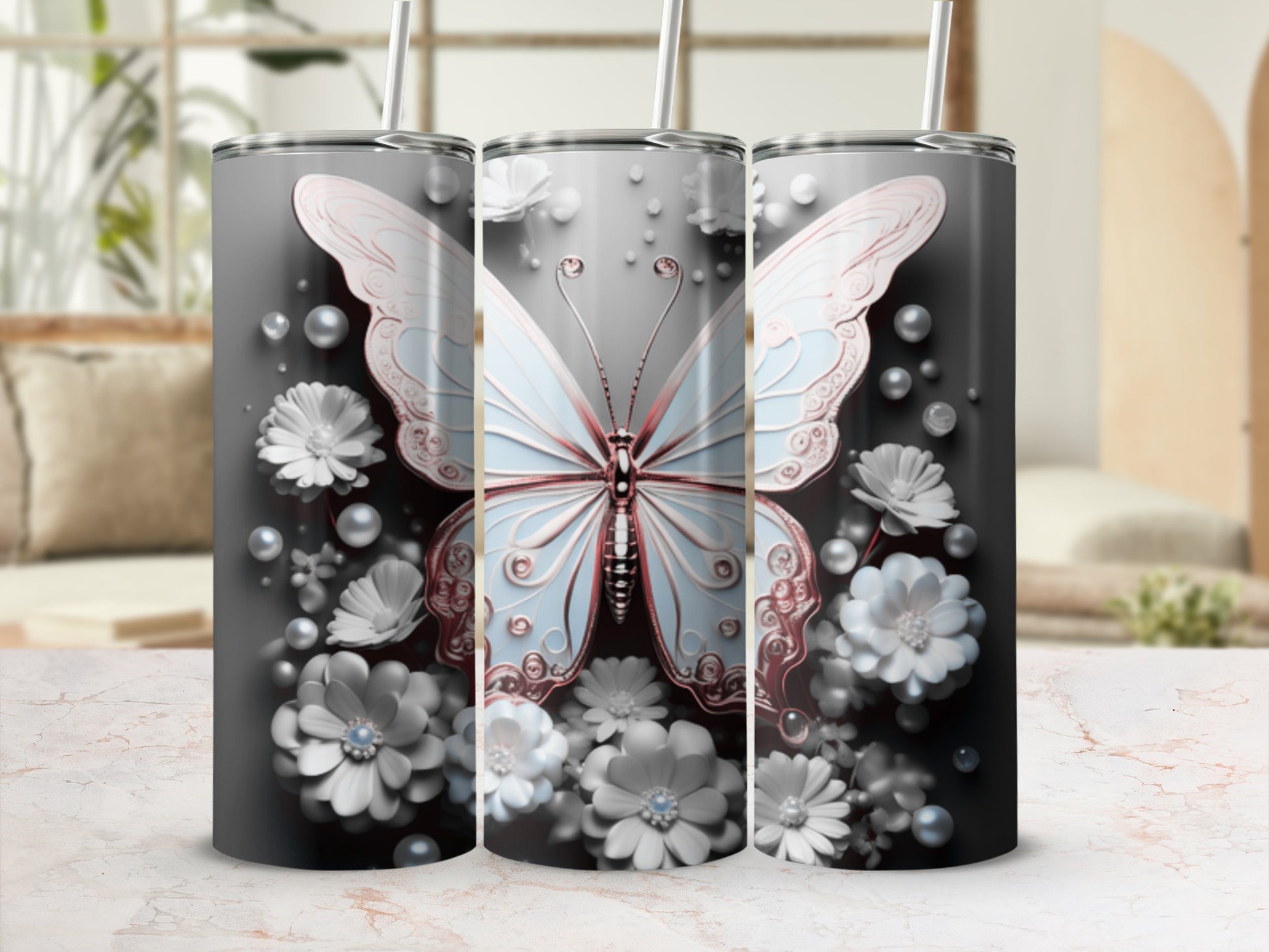 Three tumblers with a light blue butterfly and white flowers on a dark background.