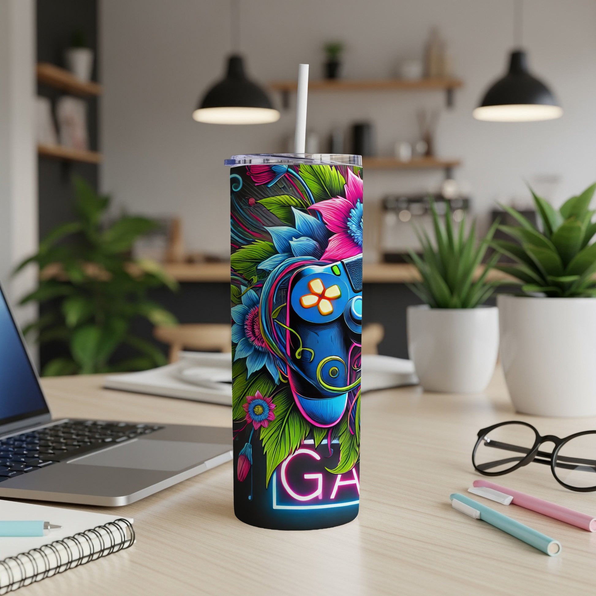 Tumbler with colorful video game controller and floral design.